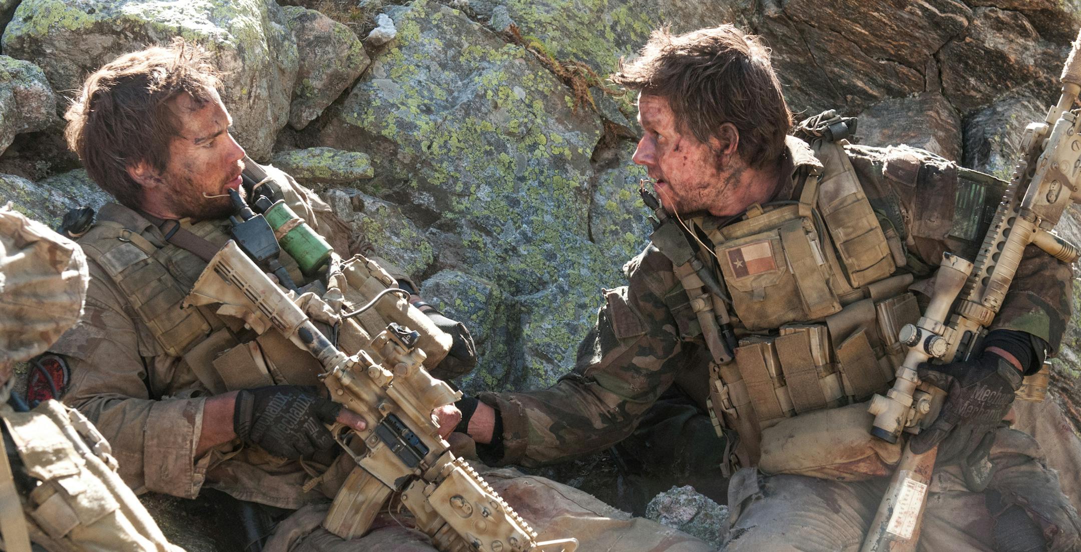 This photo released by Universal Pictures shows Taylor Kitsch, left, as Michael Murphy and Mark Wahlberg as Marcus Luttrell in a scene from the film, ìLone Survivor." (AP Photo/Universal Pictures, Gregory R. Peters)