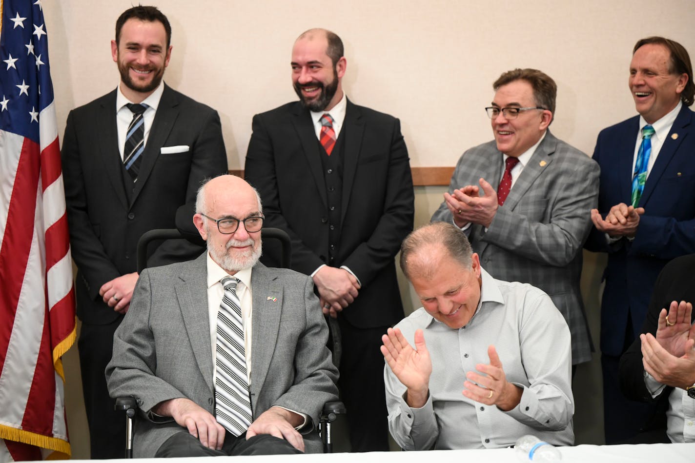 Family, politicians and ALS advocates, including professional athletes, applaud DFL Sen. David Tomassoni during a press conference highlighting S.F. 3310 and S.F. 3372, which establish grants for caregivers of ALS patients, as well as research to improve treatment and prevention of ALS Tuesday, March 1, 2022 at the Carpenter's Local 322 building in St. Paul, Minn. The senate bills were sponsored by Sen. David Tomassoni, who is battling ALS. ] AARON LAVINSKY • aaron.lavinsky@startribune.com