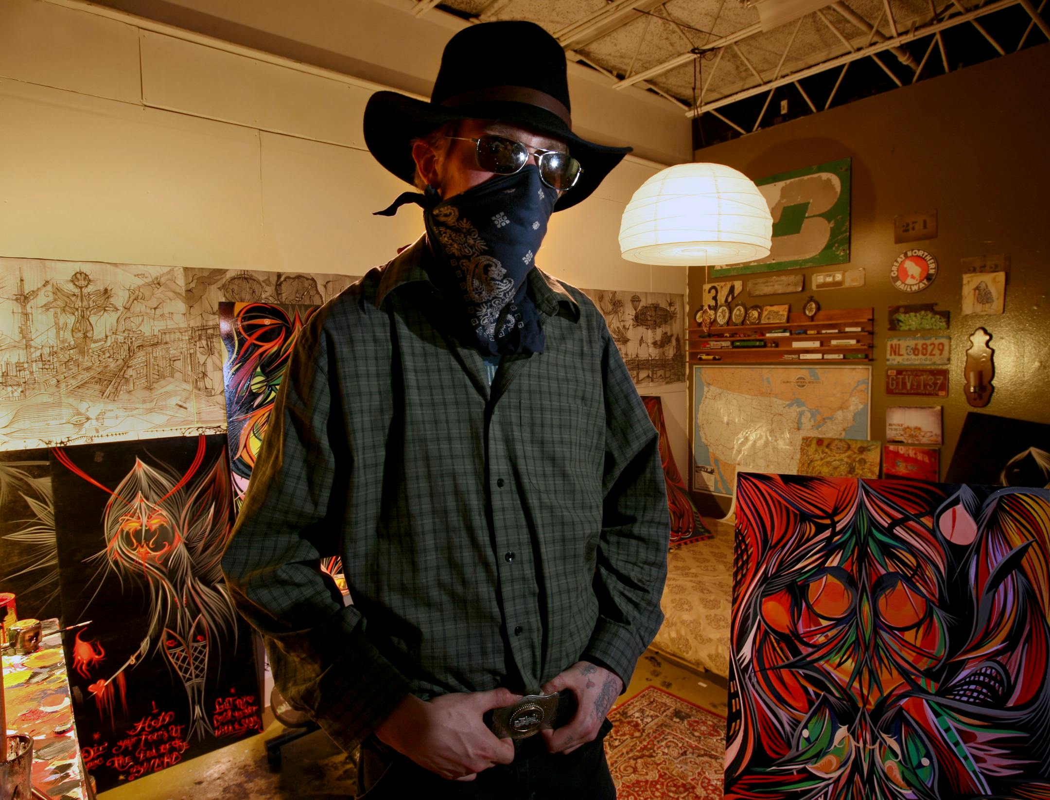 Artist Deuce 7 with curator in his loft. He will have about 10 painting and a dozen drawings in his exibit for the NE art expo, "Art-a-whirl."