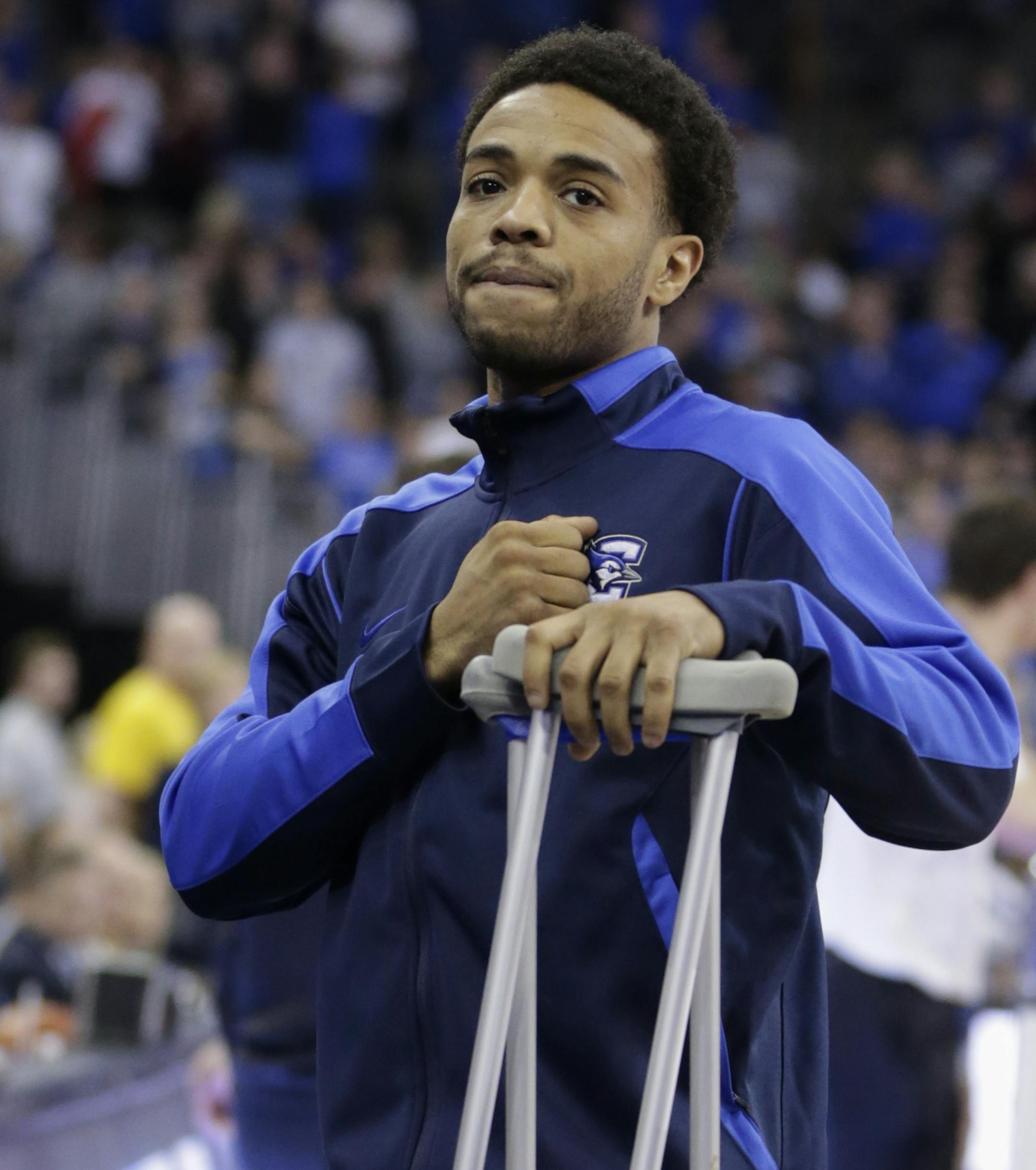 With a fist to his heart, Creighton's Maurice Watson Jr., who is out for the season with an ACL injury, acknowledges the cheers of the crowd before the first half of an NCAA college basketball game against Marquette in Omaha, Neb., Saturday, Jan. 21, 2017. (AP Photo/Nati Harnik) ORG XMIT: NENH102