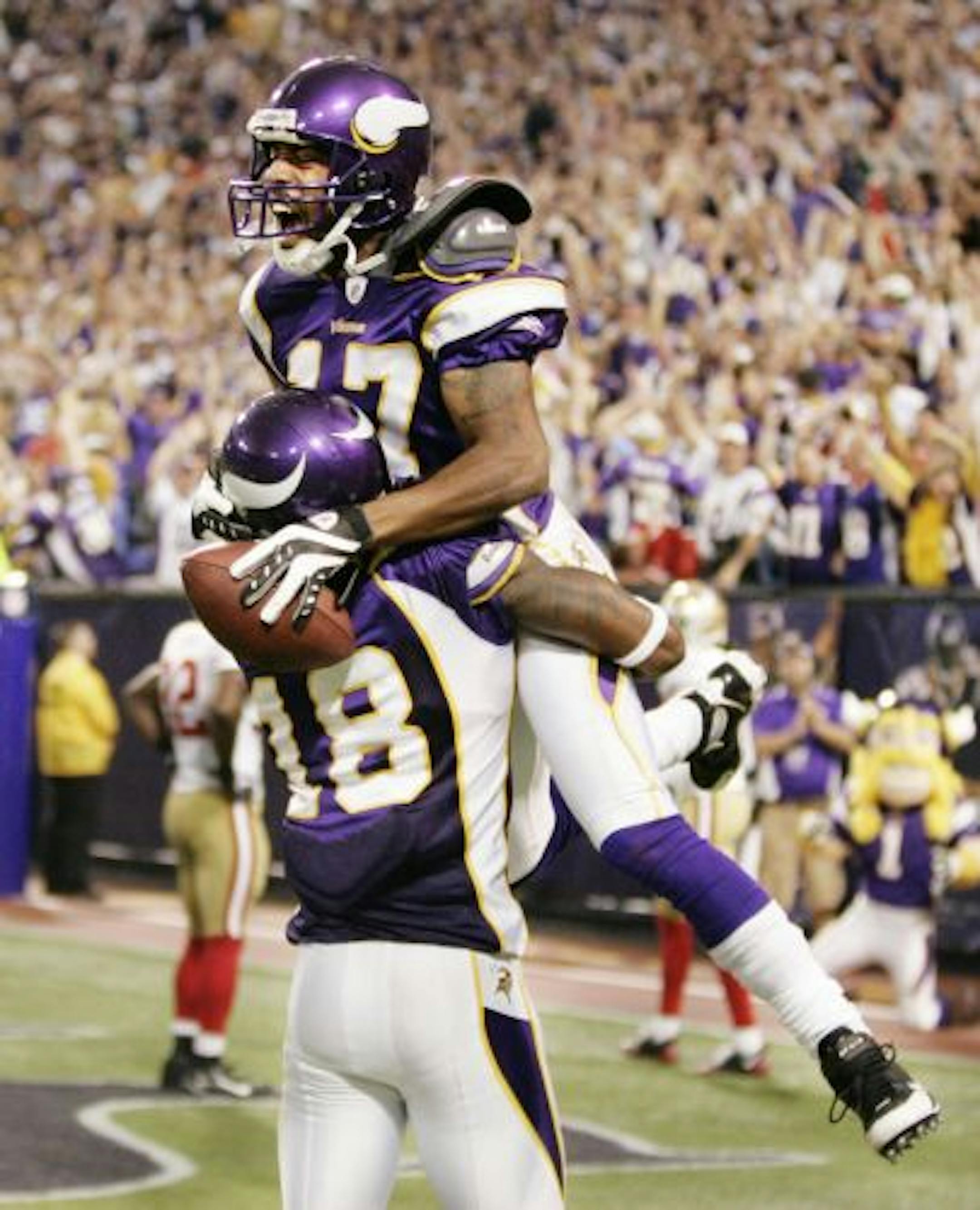 Vikings receiver Greg Lewis (17) celebrated with teammate Sidney Rice after catching his game-winning 32-yard touchdown pass from Brett Favre with two seconds left.