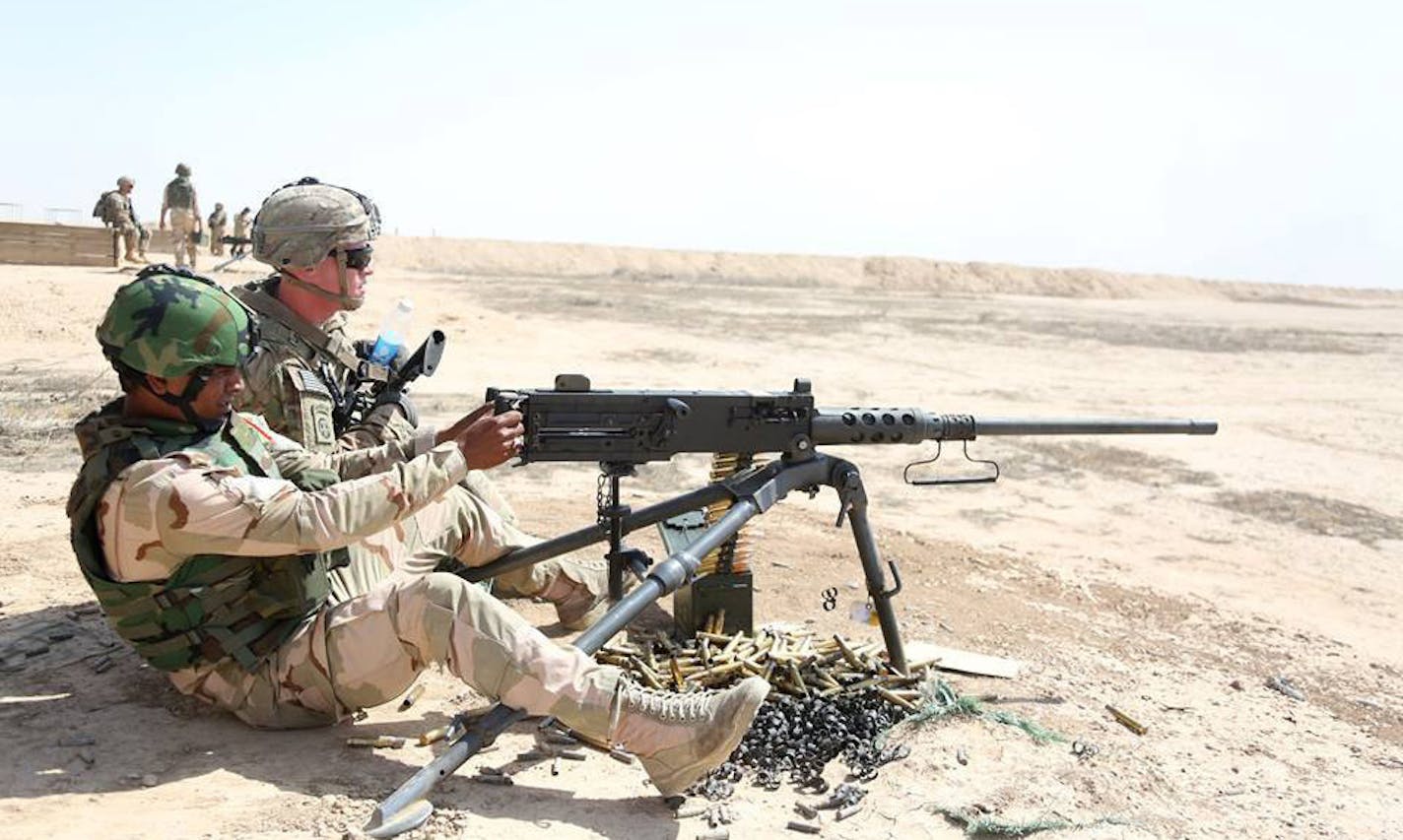 Troops from the U.S. Army's 3rd Brigade Combat Team instructed Iraqi soldiers how to use M2 machine guns at Besmaya Range Complex, Iraq.