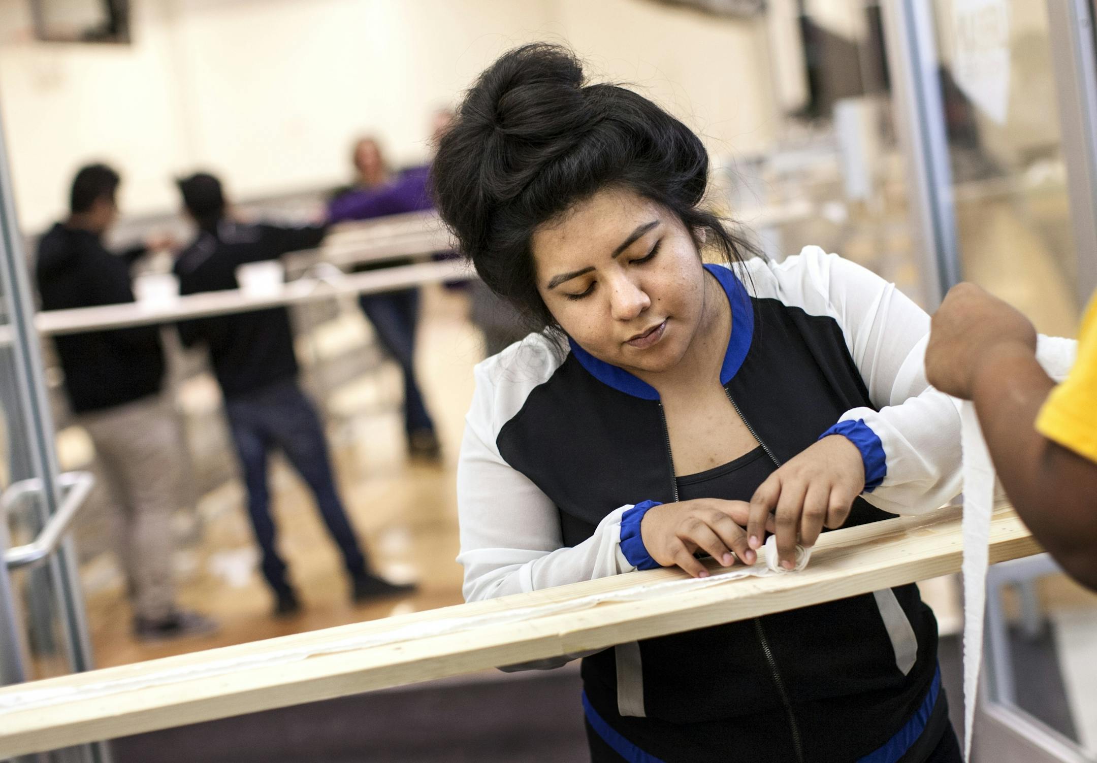 Citlally Ruiz, 15, rolls up a row of seeds ready for planting at Eat for Equity's community feast benefitting Urban Ventures at the Urban Ventures headquarters in Minneapolis January 31, 2015. The seeds will be planted in Urban Ventures' City Kid Foods' gardens.