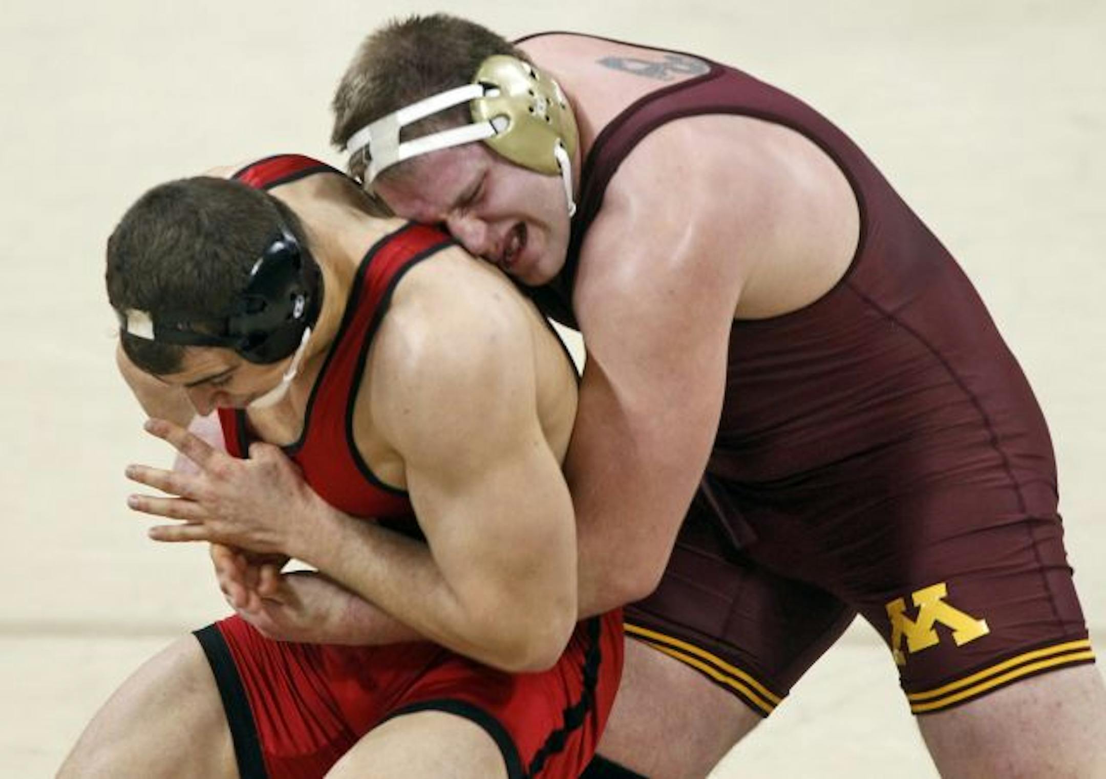 Gophers heavyweight Ben Berhow worked to control Wisconsin's Eric Bugenhagen during Sunday's final match. Berhow's 3-2 decision sealed the Gophers' 21-15 victory.