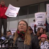 Local 1105 President Abaki Beck speaks to fellow graduate students and protesters after a student was detained by ICE.