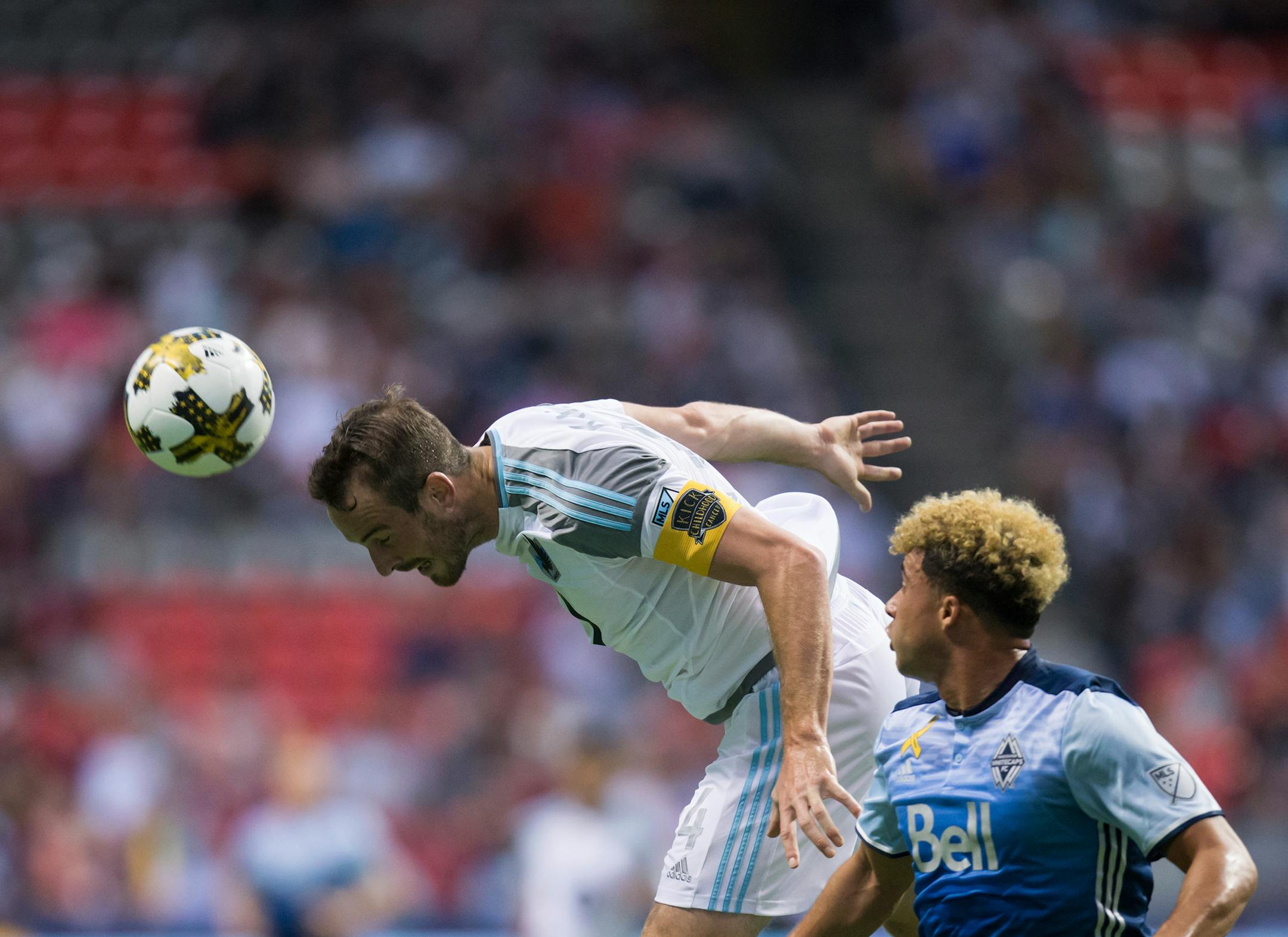 Minnesota United's Brent Kallman, left, gets his head on the ball to stop a pass intended for Vancouver Whitecaps' Erik Hurtado during the first half of an MLS soccer match Wednesday, Sept. 13, 2017, in Vancouver, British Columbia. (Darryl Dyck/The Canadian Press via AP) ORG XMIT: VCRD107