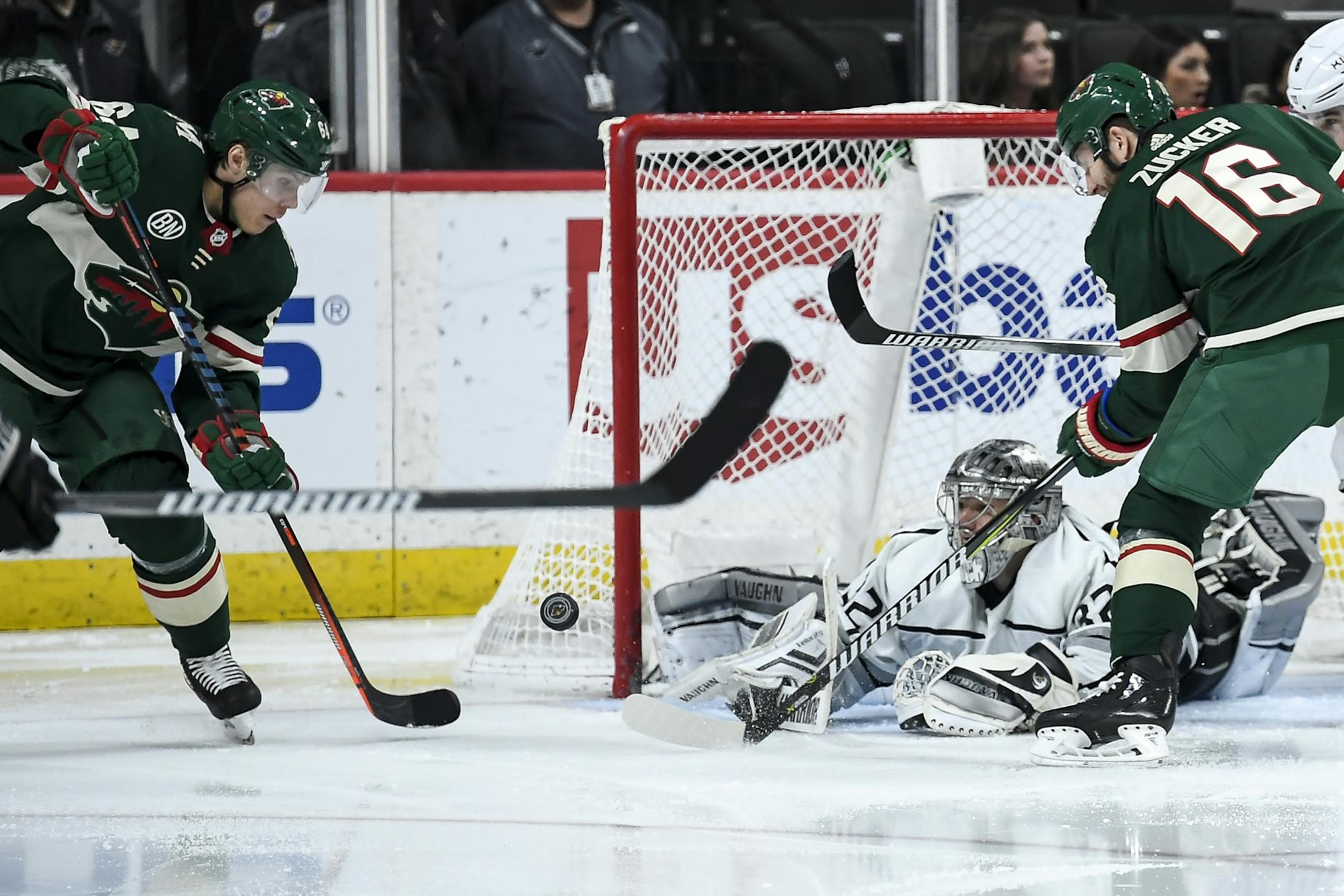 Los Angeles Kings goaltender Jonathan Quick (32) was able to stop a scoring attempt by Minnesota Wild right wing Mikael Granlund (64) and left wing Jason Zucker (16) in the second period.