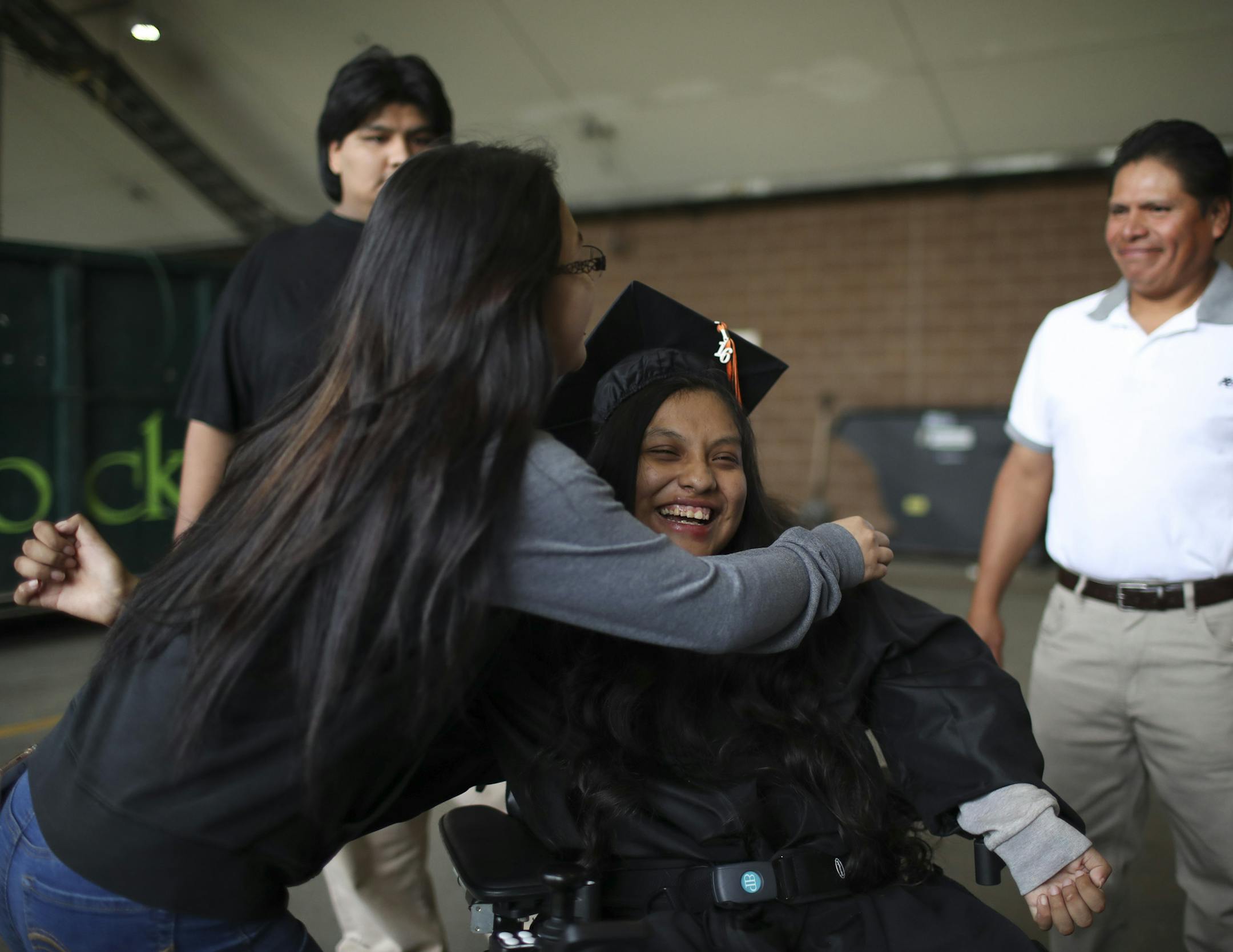 Guadalupe Galeno-Hernandez beamed as her friend, Jennifer Olivares rushed to give her a congratulatory hug after the graduation ceremony Tuesday night. Her brother, Jessie, is at rear and her stepfather, Jose Lucero is at right. ] JEFF WHEELER ï jeff.wheeler@startribune.com Guadalupe Galeno-Hernandez,18, the girl who survived being shot in the throat in November 2010 by a wannabe gangster, graduated from South High School with her class Tuesday night, May 31, 2016 at Mariucci Arena on the U