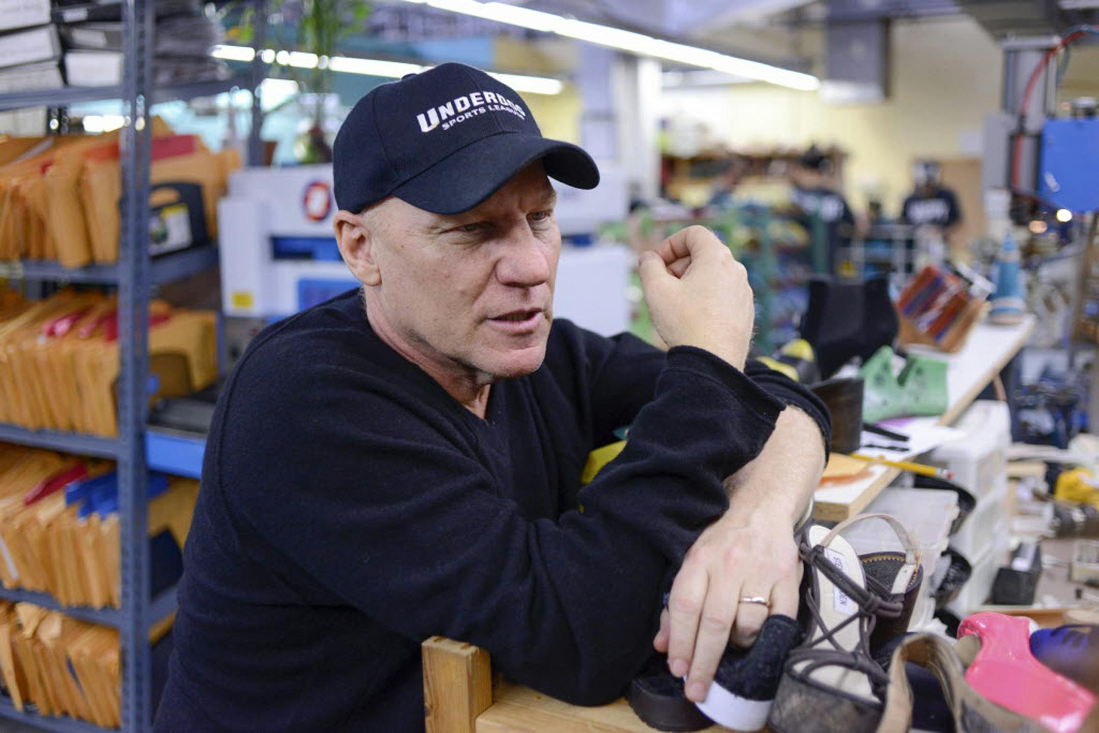 Steve Madden speaks with a designer at the Steve Madden headquarters in New York, Jan. 17, 2013. A decade after Madden served time in prison for stock fraud, his company flourishes, but it did make him reflect on his long career and love.