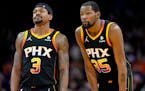 Phoenix Suns stars Bradley Beal and Kevin Durant watch a free throw during the latter stages of their loss to the Wolves on Friday night.