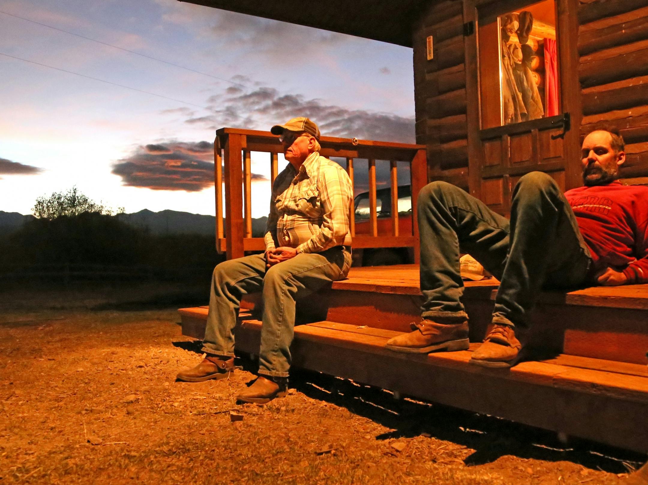 Jim Highum, 70, left, of Evansville, Minn., is a lifelong horseman who has traveled to Montana since 1965 to help rancher Dean Peterson, right, his brother, Clay, and before them their father, Harold, put up hay in summer and gather cattle from the mountains in the fall. Here they rest after a long day on horseback in the mountains that separate southwest Montana from Idaho. In the mountains, on 13,000 acres, they sought out and rounded up hundreds of the Petersons' cattle and drove them down to