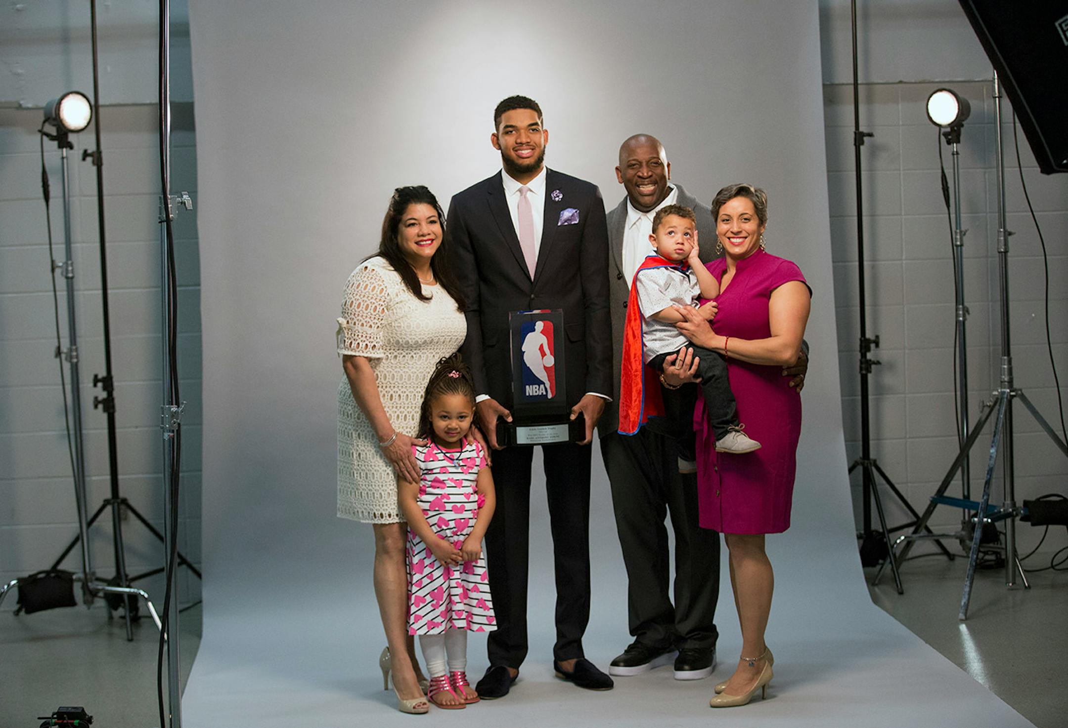 Karl-Anthony Towns poses for a portrait with his family (Mother, Father, sister and Kids) by Timberwolves team Photographer David Sherman before the announcement of his NBA Rookie of the Year Award.