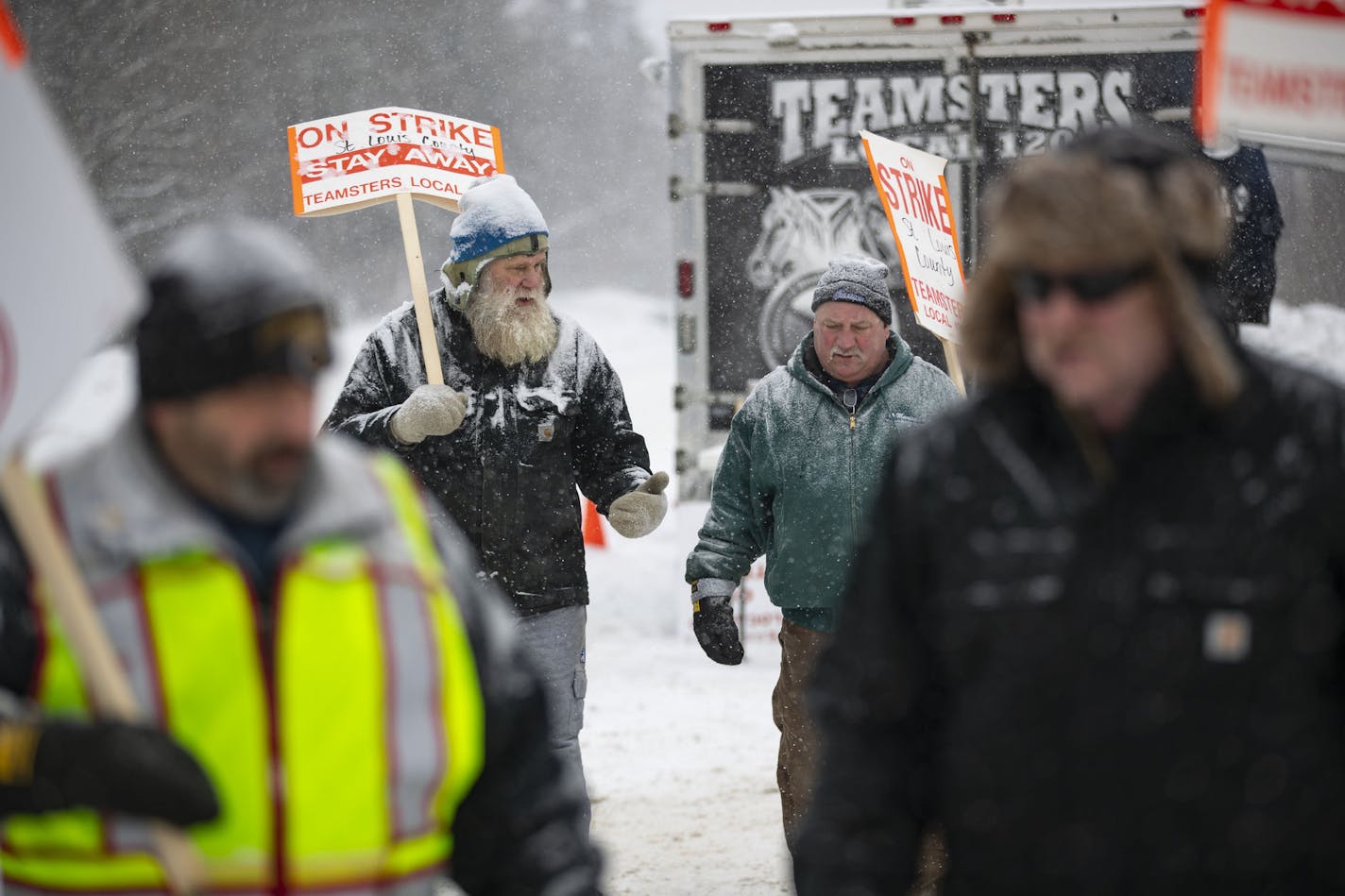 Dan Wallgren, left, spoke with Ted Krause as they walked with striking snow plow drivers who were picketing in front of the St. Louis County Public Works Department building north of Duluth on Wednesday. ORG XMIT: MIN2001151528311772