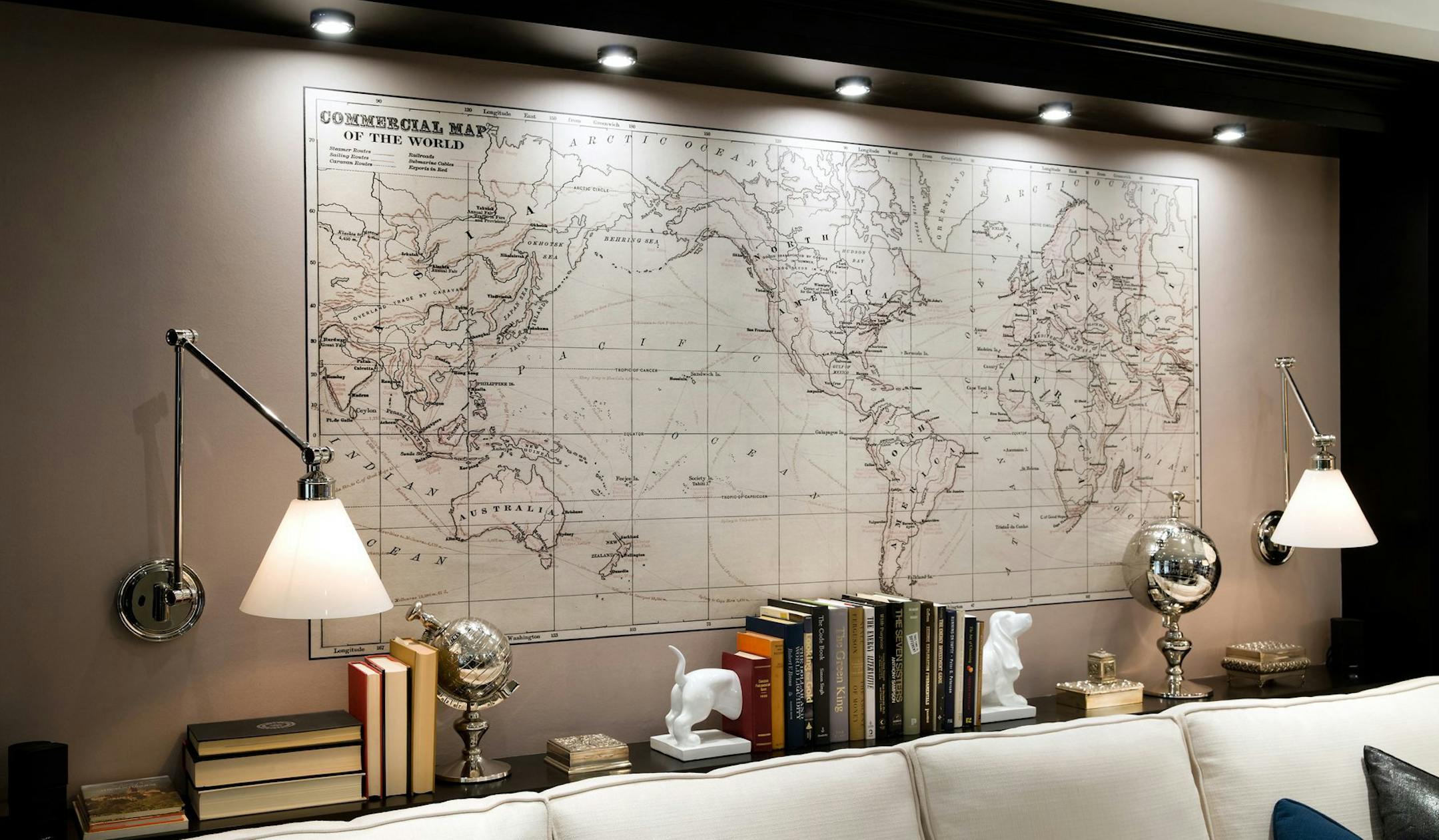 Homeowners Bob and Alice have travelled extensively, so on the wall opposite the fireplace, a mural depicting a map of the world in muted browns and creams is highlighted. The wall, on which the couch also sits, has two wall-mounted lights - on flexible arms so they can be perfectly positioned as over-the-shoulder reading lamps. (Brandon Barre/MCT) ORG XMIT: 1147219