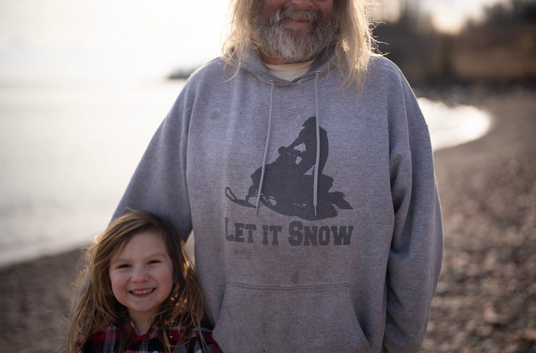 Eric Sve and his nephew’s daughter, Karsyn, stopped during their walk Sunday along the shore of Lake Superior near the Split Rock River outside Two Harbors, Minn.