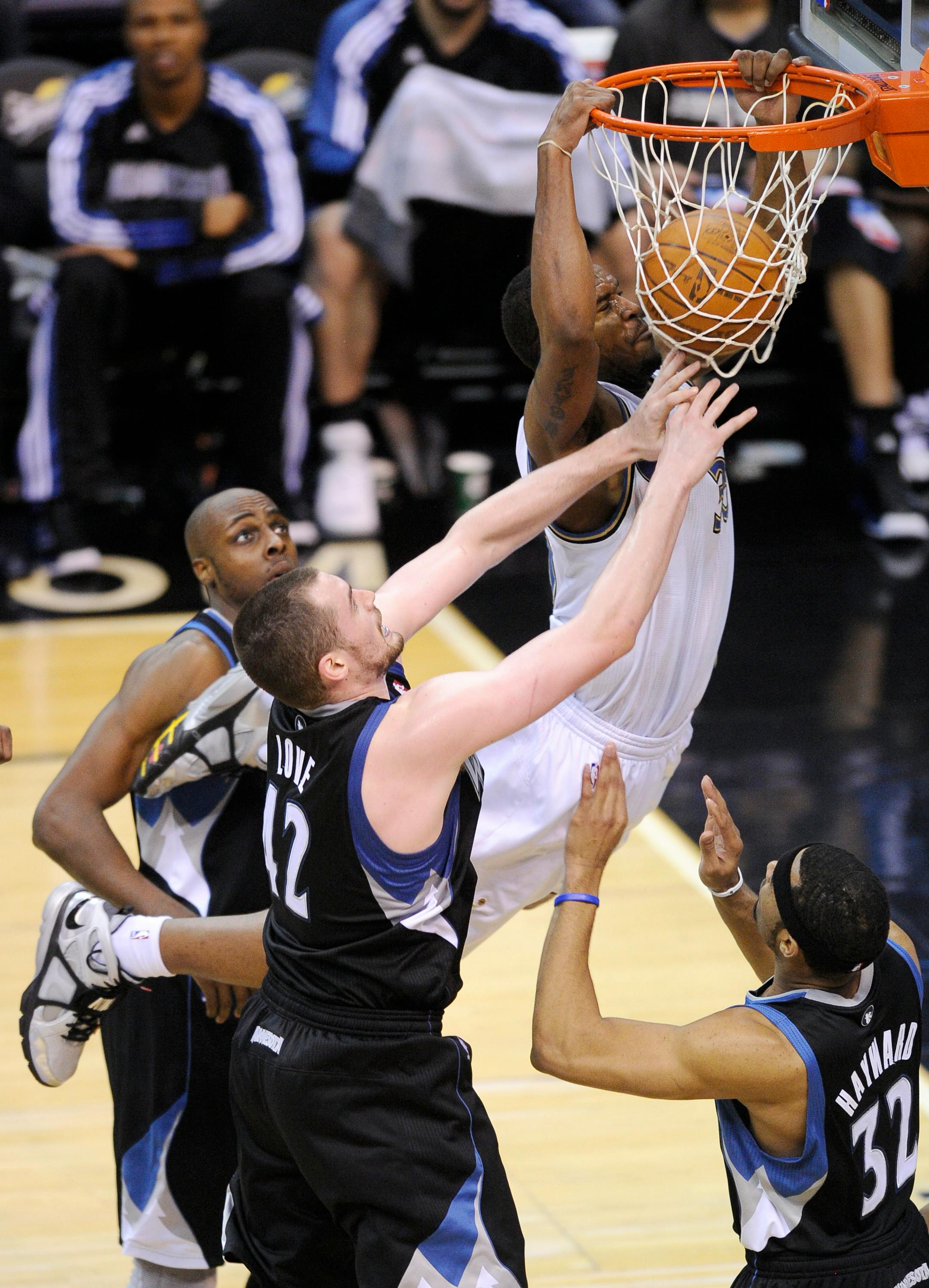 Washington Wizards center Trevor Booker, back right, dunks against Minnesota Timberwolves power forward Kevin Love (42) and Lazar Hayward (32) during the second half of an NBA basketball game, Saturday, March 5, 2011, in Washington. The Wizards won 103-96. (AP Photo/Nick Wass)
