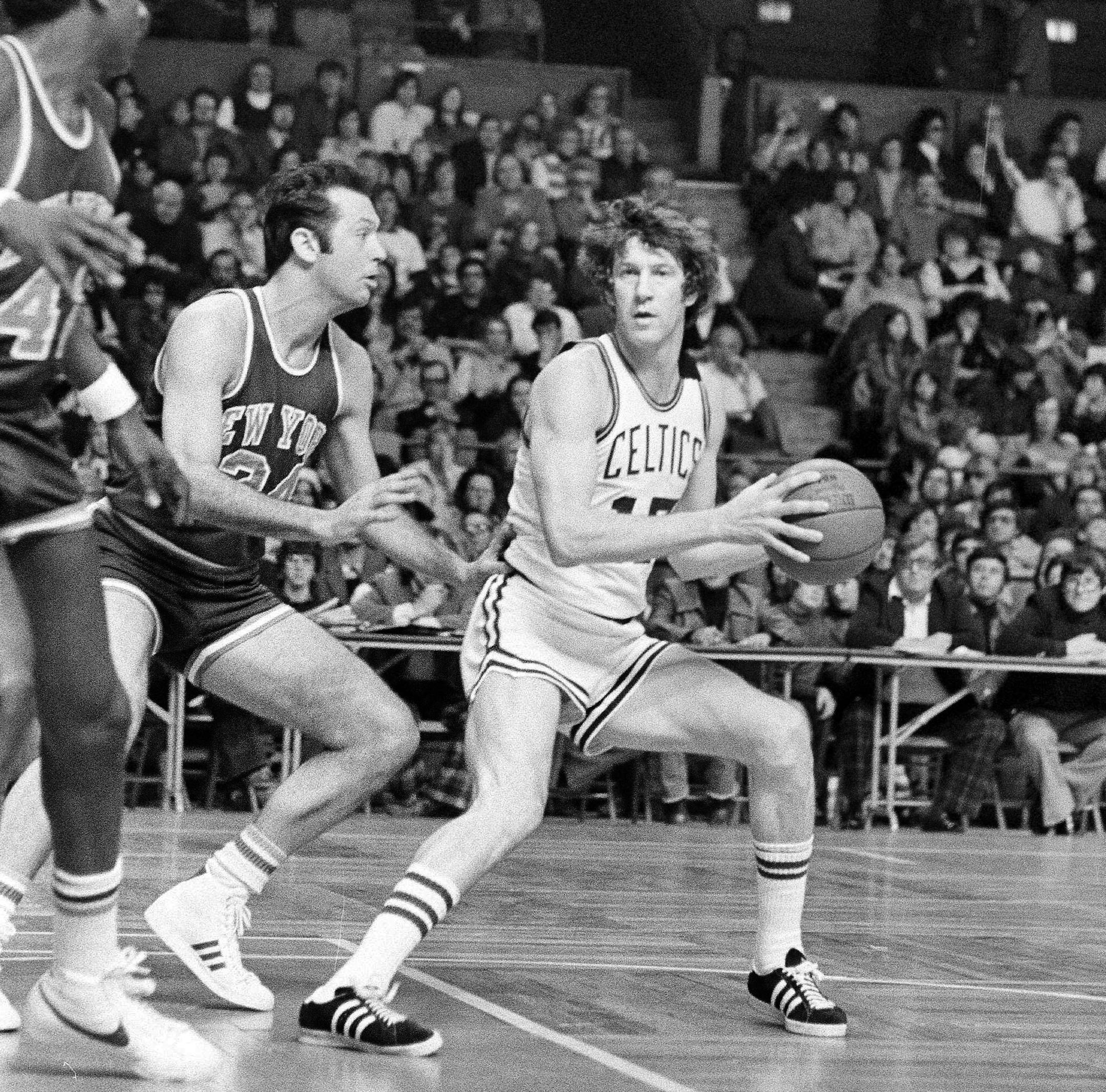 Boston Celtics' John Havlicek, right, looks for teammate to pass to, as New York Knicks' Bill Bradley moves in on him during their NBA game at Boston Garden, Feb. 9, 1976. New York won the game 97-89. (AP Photo/Peter Southwick) ORG XMIT: APHS455557