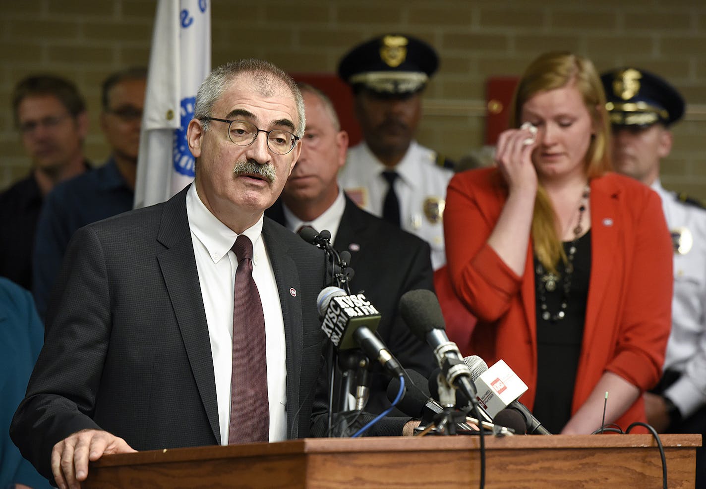 Chancellor of the Minnesota State Colleges and Universities system Steven Rosenstone, left, talks about the loss of St. Cloud State University President Earl H. Potter III while SCSU Student Government President Mikaela Johnson wipes away tears during a press conference Tuesday, June 14, 2016, at St. Cloud State University in St. Cloud, Minn. SCSU President President Earl H. Potter III died in a one-vehicle crash Monday night in Brooklyn Center, Minn. (AP Photo/St. Cloud Times via AP)