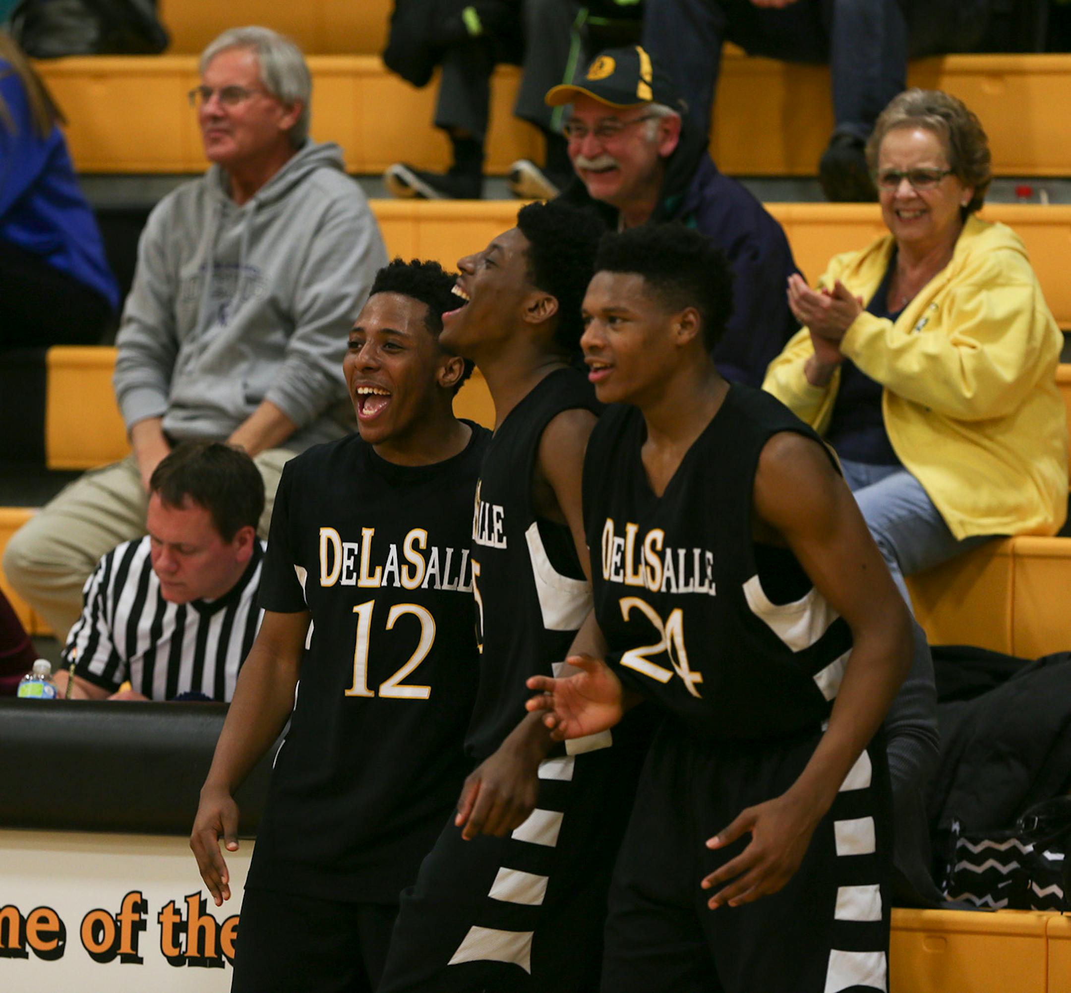 With a comfortable lead late in the game against Fridley, DeLaSalle's Jarvis Johnson, Sacar Anim, and Joshua Collins, from left, enjoyed watching their teammates finish the game from the bench at DeLaSalle. ] JEFF WHEELER ï jeff.wheeler@startribune.com DeLaSalle High School trounced Fridley 69-31 in a boy's basketball game Thursday night, February 12, 2015 at DeLaSalle. The Islanders' Jarvis Johnson is the top preps hoops player in the state and the Gophers' No. 1 recruit for 2015.