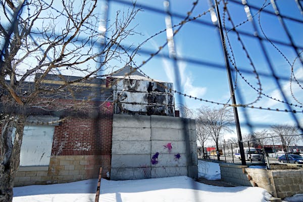The former Minneapolis police Third Precinct building still stands in its burnt-out state at Lake Street and Minnehaha Avenue. The city is gathering f
