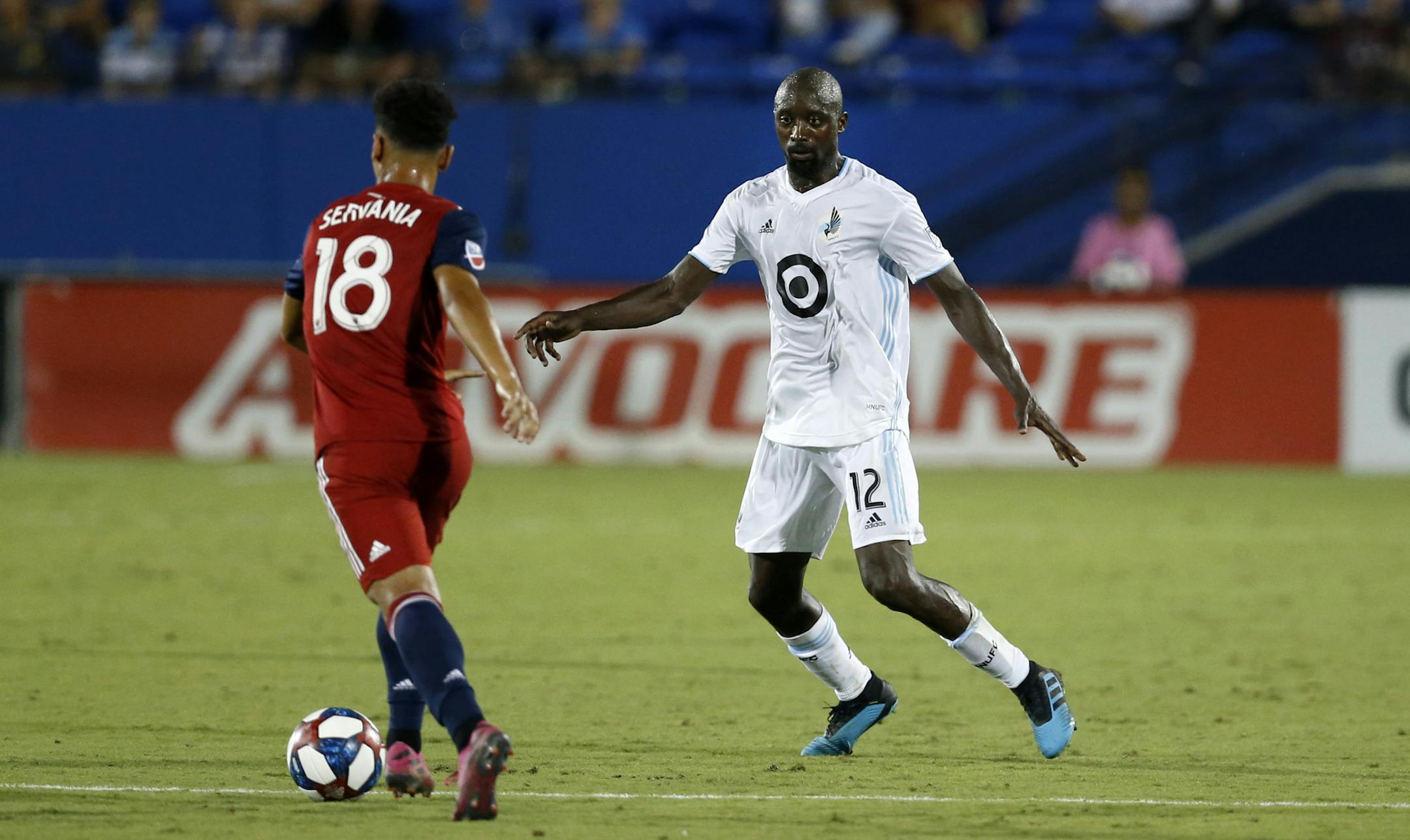Minnesota United defender Lawrence Olum, 12, defends as FC Dallas midfielder Brandon Servania attempts to advance the ball during the second half of an MLS soccer match in Frisco, Texas, Saturday, Aug. 10, 2019. FC Dallas beat Minnesota United 5-3. (AP Photo/Roger Steinman)