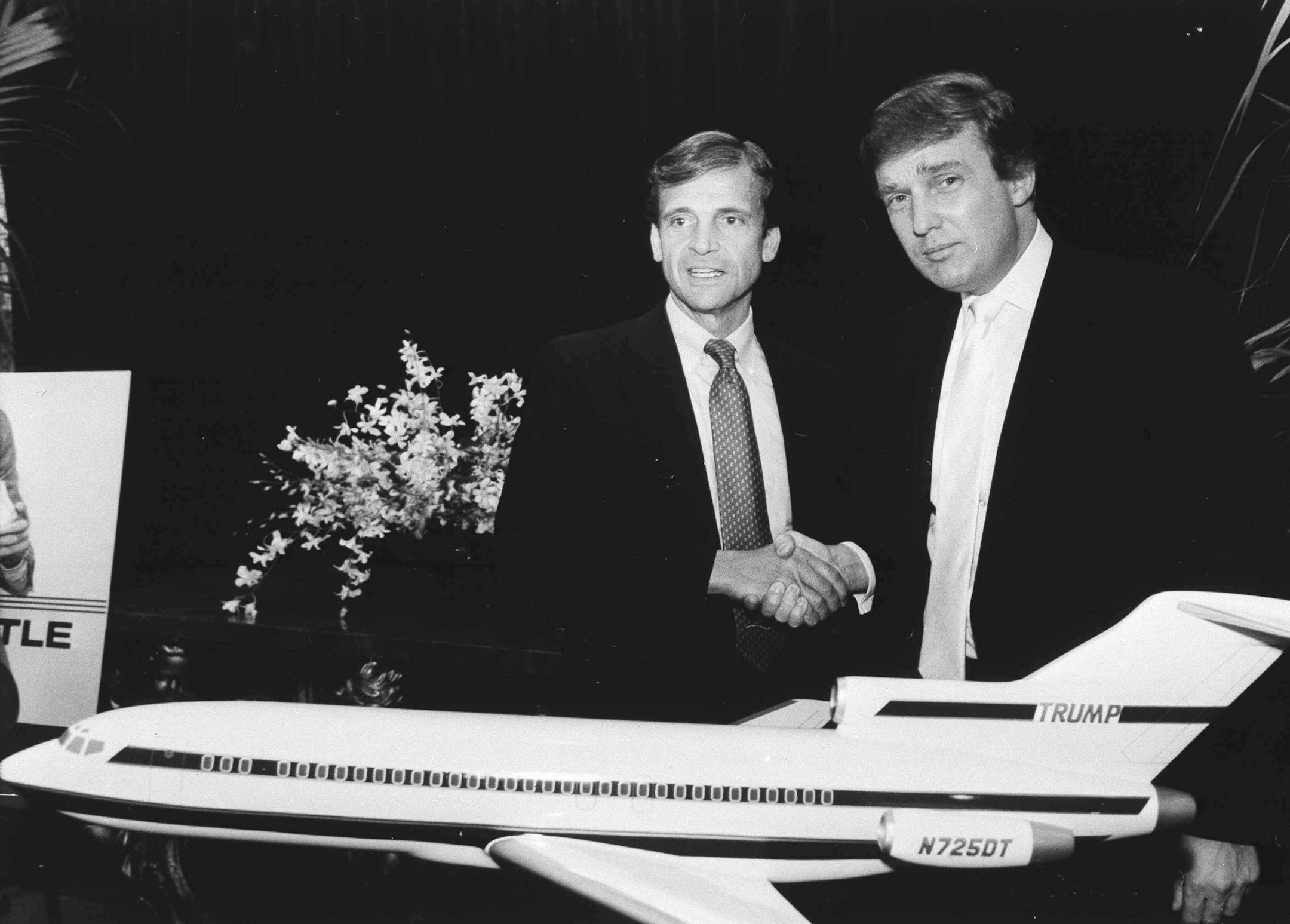Real estate mogul Donald Trump, right, shakes hands with Texas Air Corp. Chairman Frank Lorenzo during a joint news conference on Wednesday, Oct. 13, 1988 at the Plaza Hotel in New York. Trump ended a week of speculation by announcing he has agreed to buy Eastern Airlines&#xed; profitable Northeast air shuttle for $365 million in cash. (AP Photo/Richard Drew) ORG XMIT: APHS320039