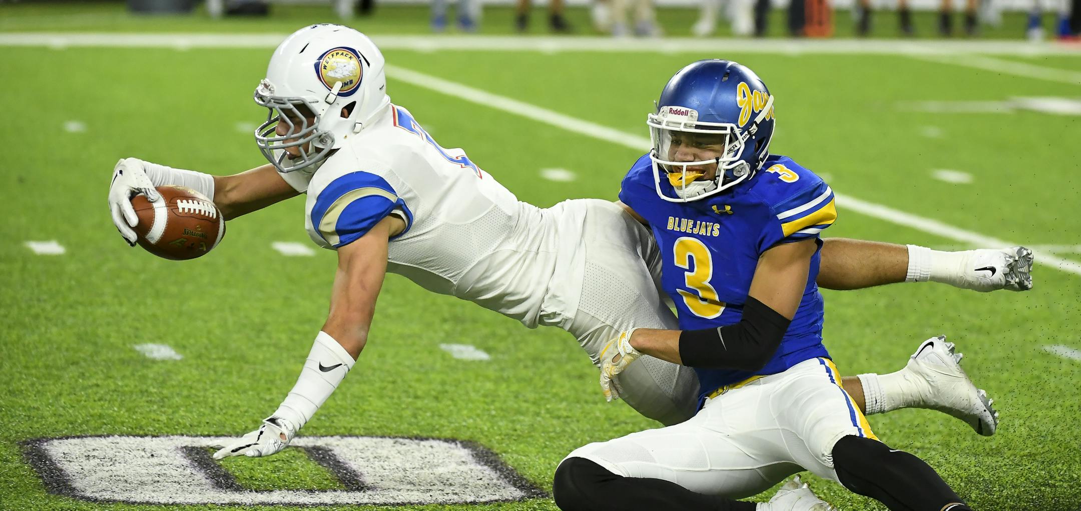 After making a first down catch on a pass thrown by quarterback Jalen Suggs (1), SMB defensive back Craig McDonald (7) lunged for the extra yard while he was tackled by Waseca defensive back Malik Willingham (3) in the first half. ] Aaron Lavinsky • aaron.lavinsky@startribune.com SMB played Waseca in a Class 4A state tournament semifinal football game on Thursday, Nov. 15, 2019 at US Bank Stadium in Minneapolis, Minn.