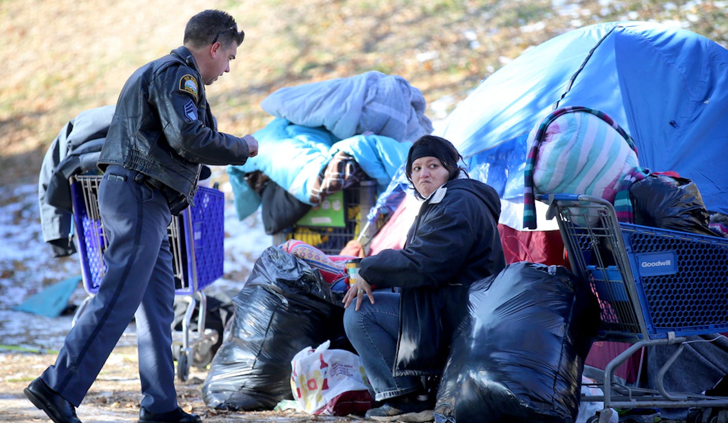 St. Paul officials began clearing out the St. Paul homeless near the Cathedral of St. Paul Wednesday, Nov. 15, 2018, in St. Paul, MN. Here, a homeless woman who did not want to give her name, gives information to a St. Paul police officer who was trying to find her shelter space.] DAVID JOLES • david.joles@startribune.com St. Paul officials are to begin clearing out the St. Paul homeless**Michelle Stevens, Stephanie Stuart, cq