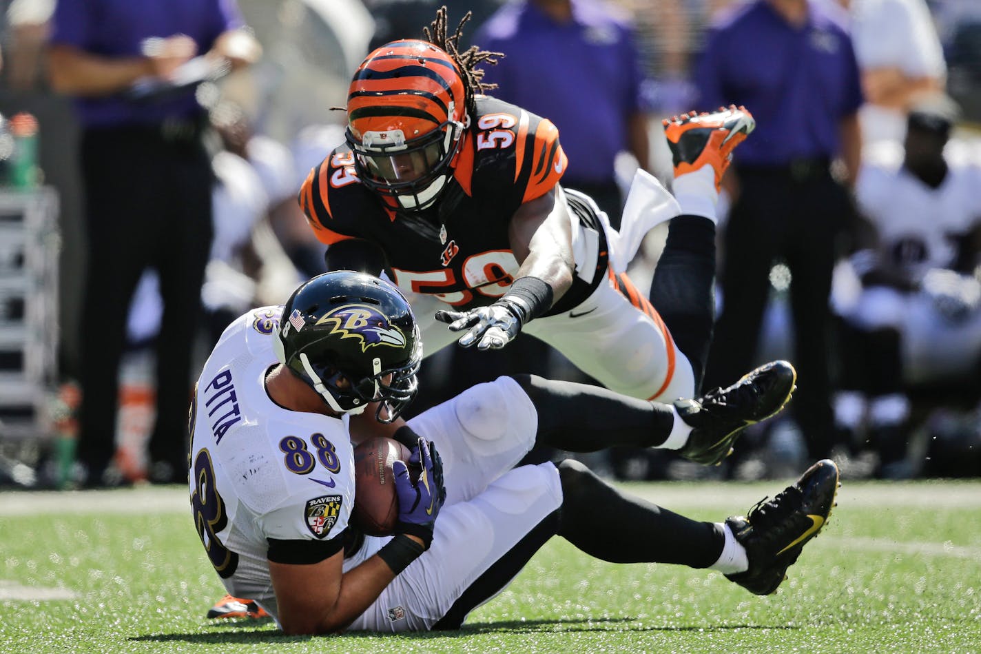 Cincinnati Bengals linebacker Emmanuel Lamur (59) leaps toward Baltimore Ravens tight end Dennis Pitta (88) during the second half of an NFL football game in Baltimore, Md., Sunday, Sept. 7, 2014. (AP Photo/Patrick Semansky) ORG XMIT: BAF121