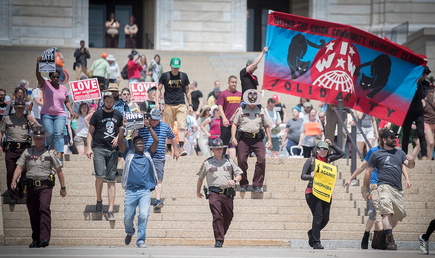 An anti-Sharia law group and antifascist protesters clashed during dueling rallies at the Minnesota State Capitol, Saturday, June 10, 2017 in St. Paul, MN. When a small faction of the anti-sharia group challenged the protesters outside, the Minnesota State Patrol had to intervene. ] ELIZABETH FLORES � liz.flores@startribune.com