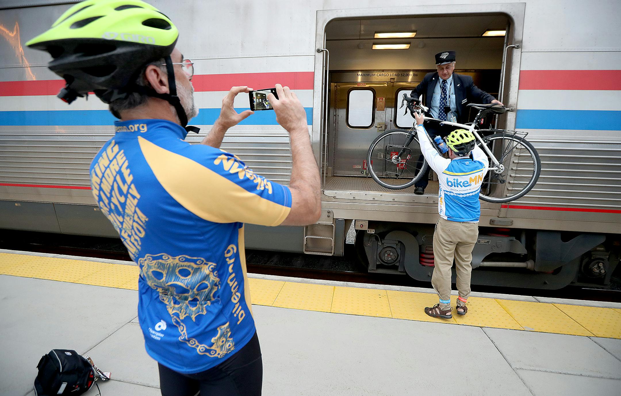 Amtrak Train Conductor Paul Trossen, cq, helped passengers lift their bikes onto the train, Monday, September 19, 2016 at the Union Depot in St. Paul, MN. Amtrak is expanding the ability of its passengers to bring their bikes along for the ride on its train network. ] (ELIZABETH FLORES/STAR TRIBUNE) ELIZABETH FLORES &#x2022; eflores@startribune.com