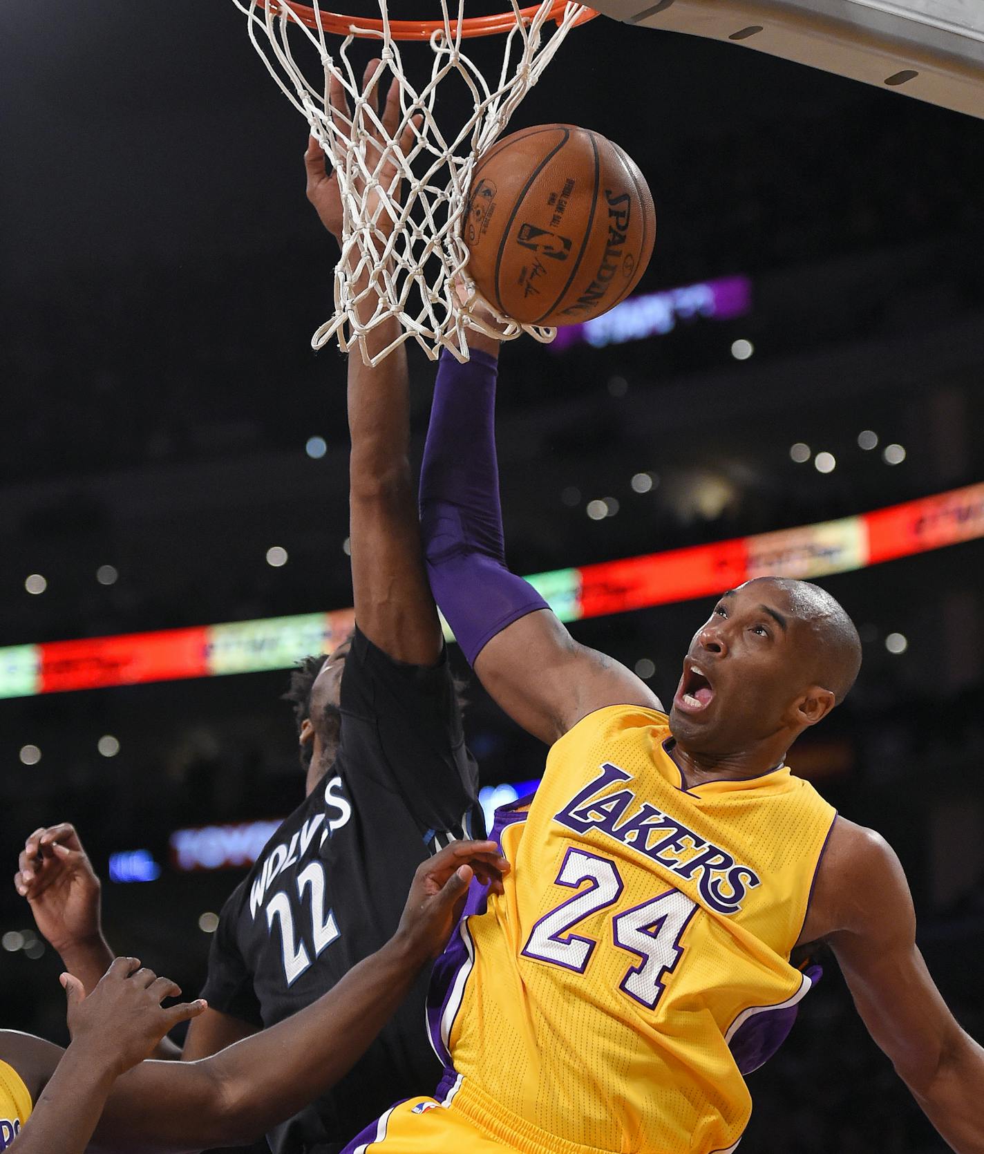 Minnesota Timberwolves guard Andrew Wiggins (22) and Los Angeles Lakers forward Kobe Bryant reach for a rebound during the first half of an NBA basketball game, Tuesday, Feb. 2, 2016, in Los Angeles. (AP Photo/Mark J. Terrill)