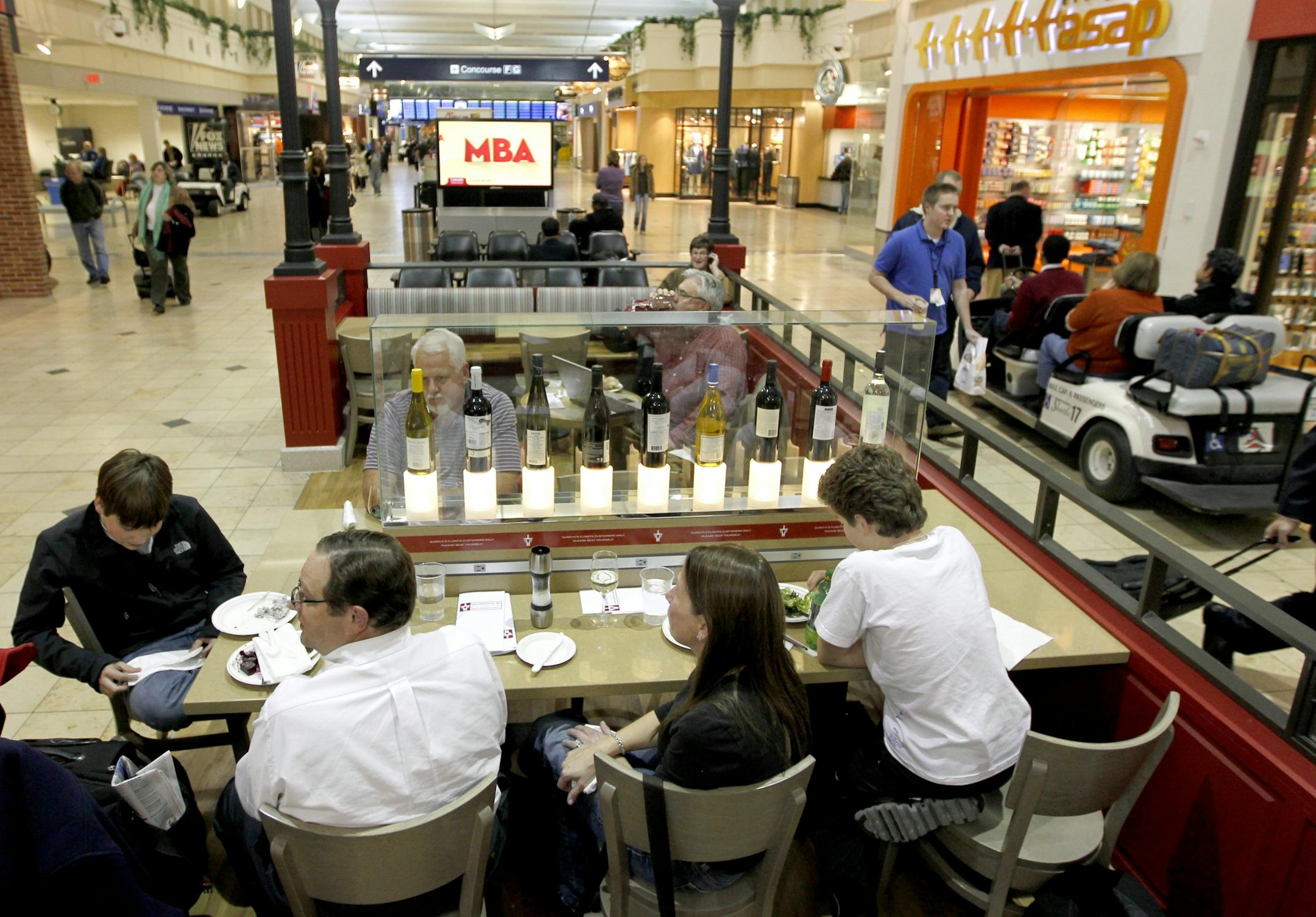 The Airport Bar/restaurants go for a better product and service for the traveler. The patio at the Surdyk's MSP airport store was a perfect place for the Berman family to catch a bite to eat and a nice glass of wine. They were headed to Boston to Share in Dad' birthday present. Tickets to the Vikings Patriots game. They are from Left Jacob, dad Rusell, mom, Lori and Josh.