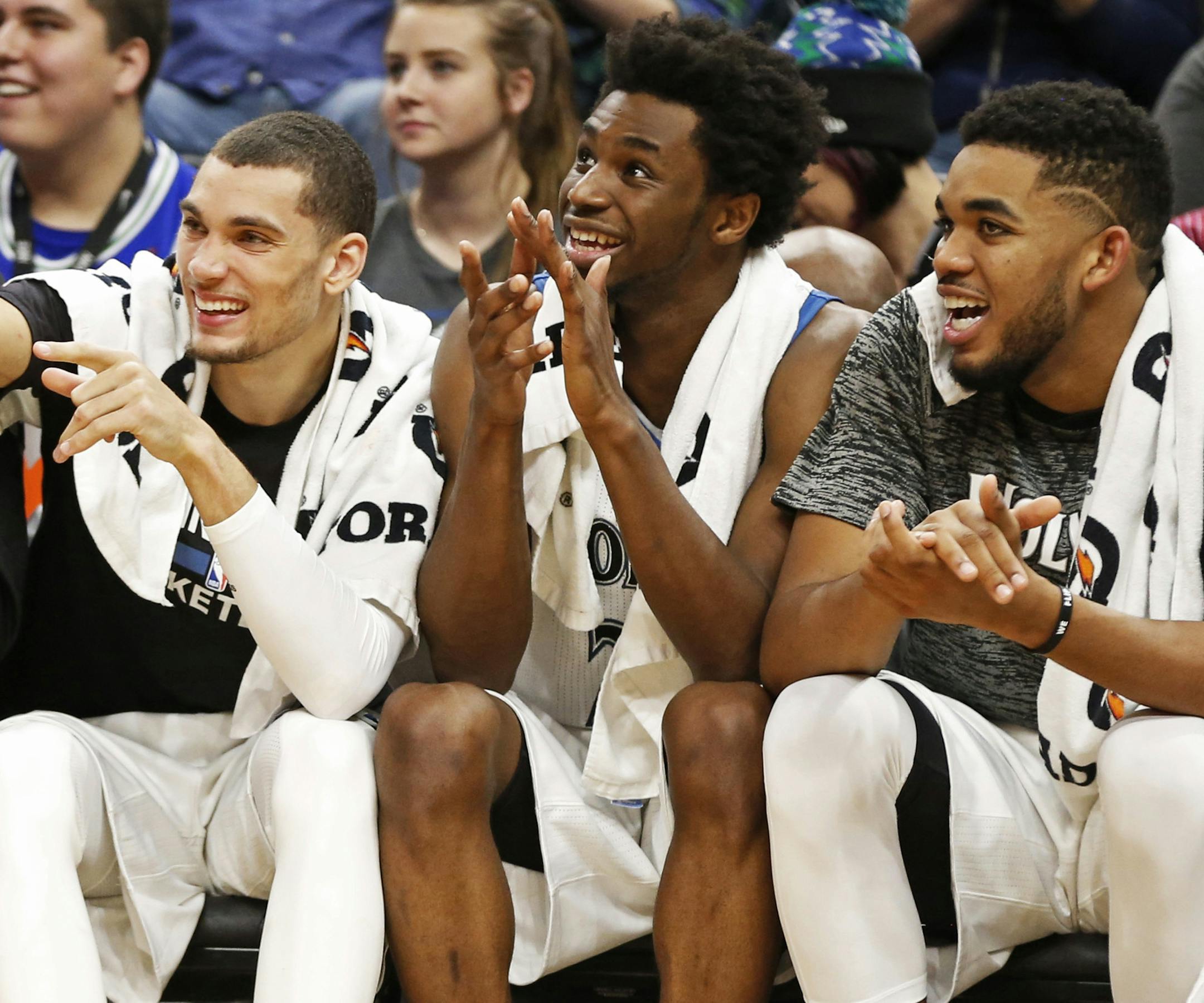 Minnesota Timberwolves' Zach LaVine, left, Andrew Wiggins, center and Karl-Anthony Towns watch the team's NBA basketball game against the Memphis Grizzlies on Tuesday, Nov. 1, 2016, in Minneapolis. The Timberwolves won 116-80. (AP Photo/Jim Mone) ORG XMIT: MIN2016110623411363