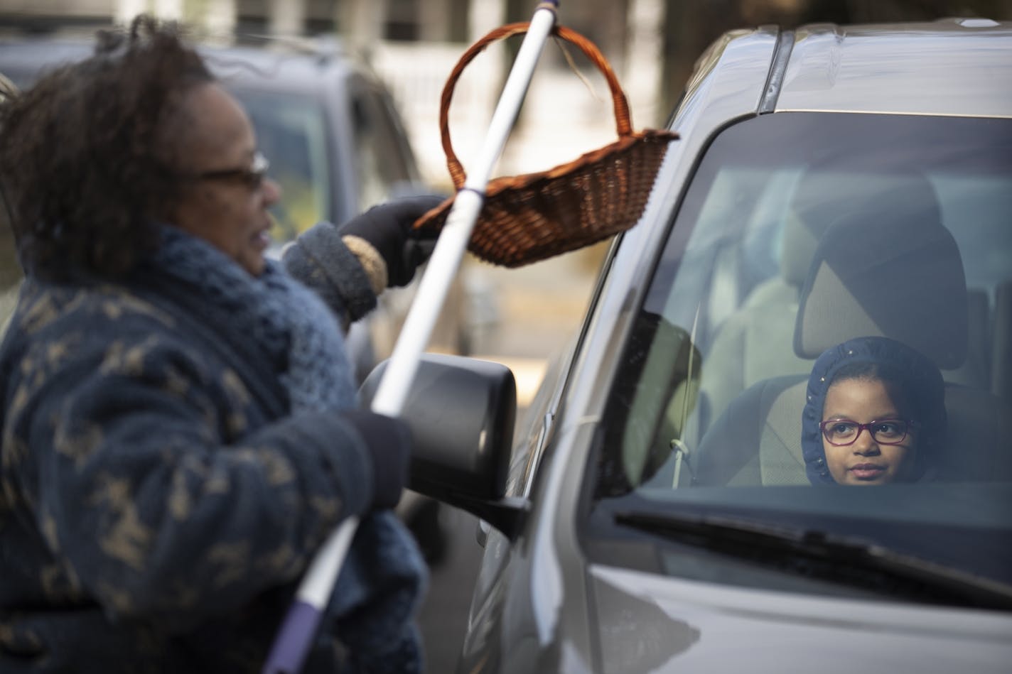 Mackenzie Thimm 8, watched from her family's car as former Minneapolis Mayor Sharon Sayles Belton collected offerings from members of Park Avenue United Methodist Church on Sunday, March 22.