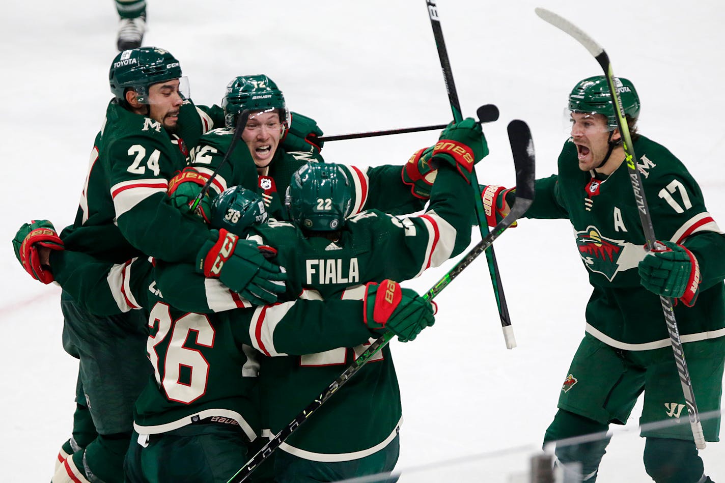 Minnesota Wild right wing Mats Zuccarello (36) celebrates with teammates Matt Dumba (24), Matt Boldy (12), Kevin Fiala (22) and Marcus Foligno (17) after scoring the tying goal during the third period of an NHL hockey game against the Washington Capitals, Saturday, Jan. 8, 2022, in St, Paul, Minn. (AP Photo/Andy Clayton-King)