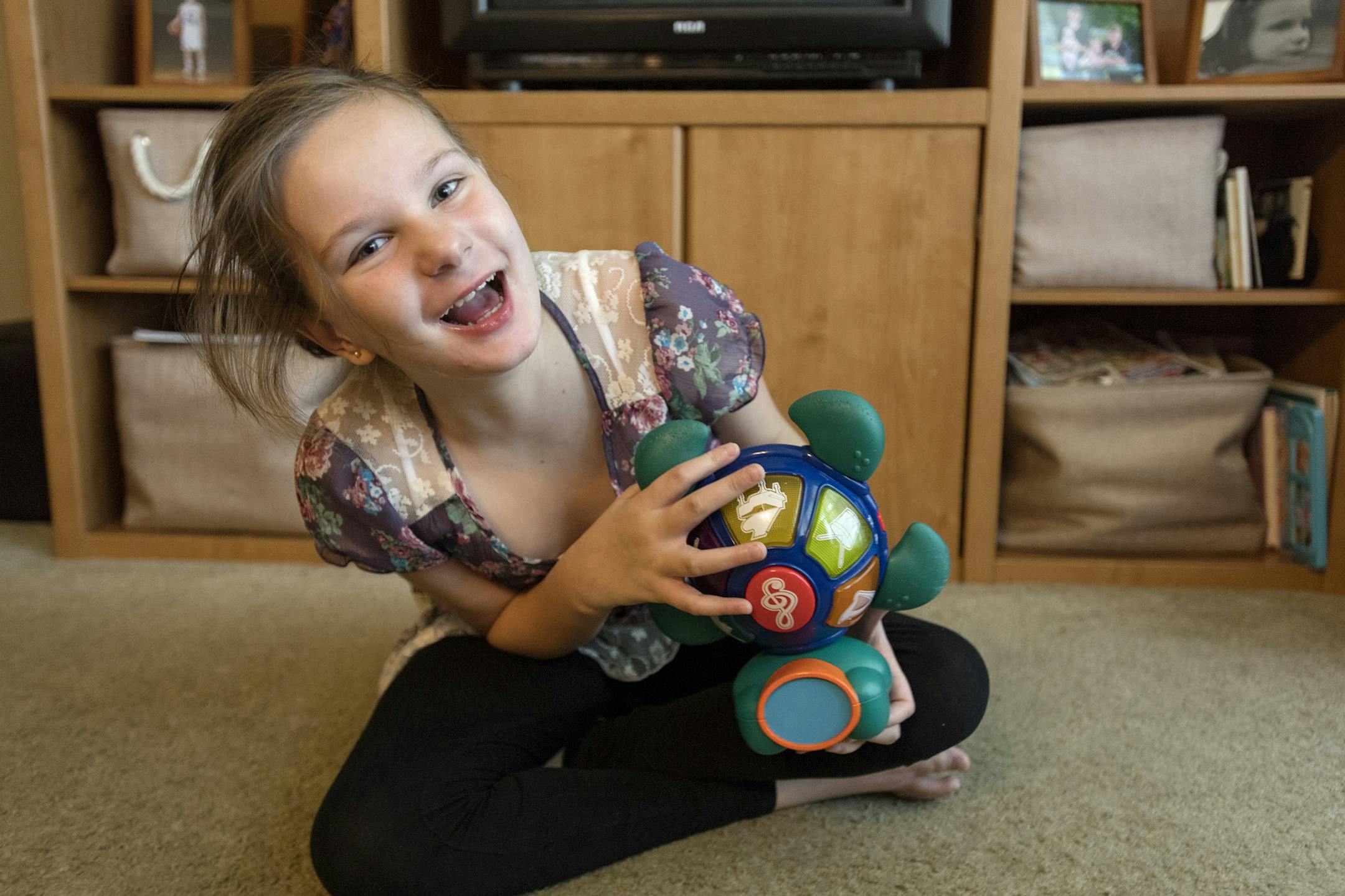 Eleven year old Leah Williams giggles as she plays with a light up and musical turtle in her family's living room on Wednesday, Sept. 7, 2016 in Kylertown, Pa. Leah is one of 9 females in the country with a rare gene mutation that has led to 30 or more gene mutations. (Abby Drey/Centre Daily Times/TNS) ORG XMIT: 1189911
