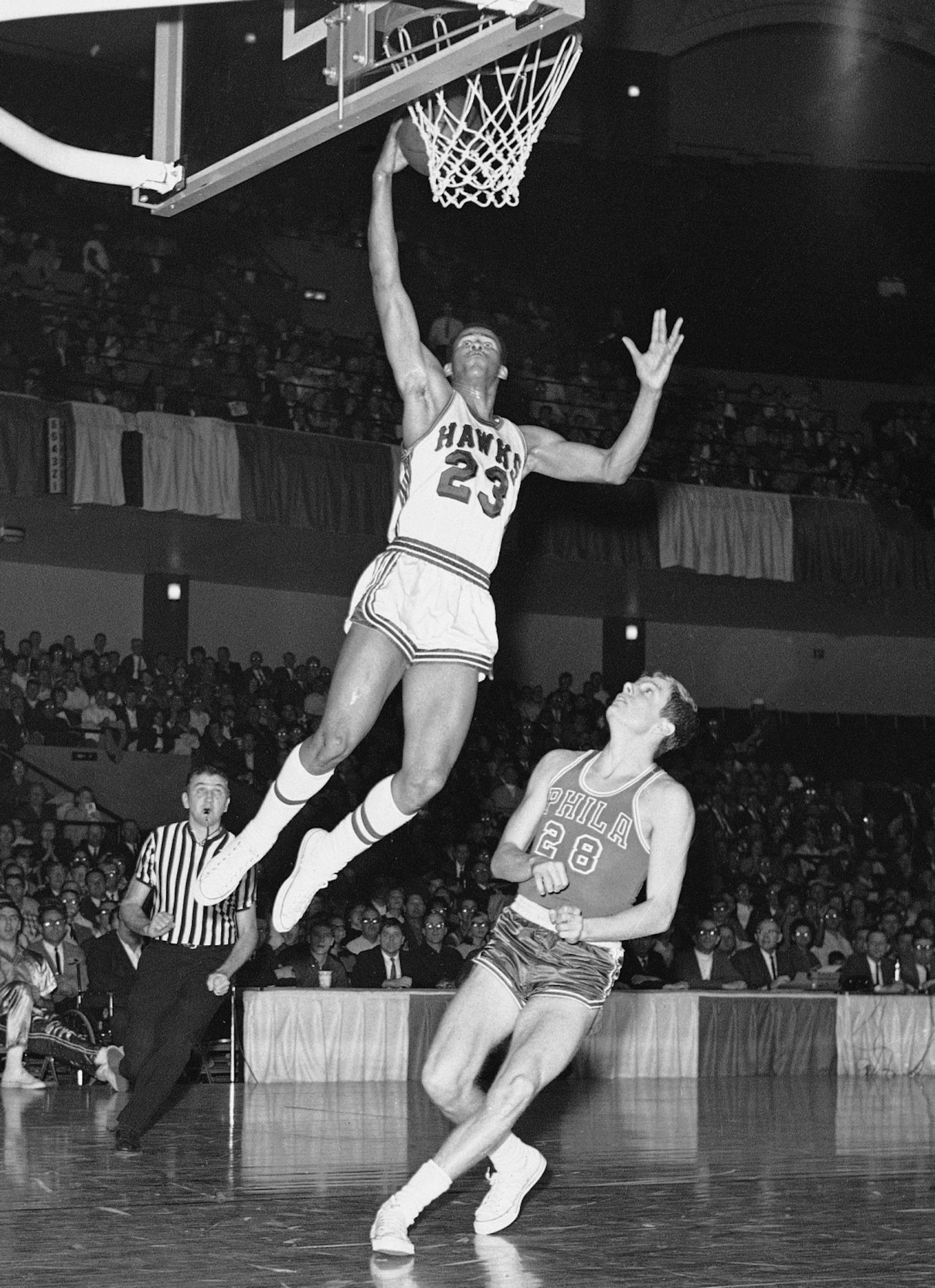 FILE - In this Jan. 31, 1967 file photo, St. Louis Hawks rookie forward Lou Hudson (23) goes to the basket against Philadelphia's Bill Melchionni, in St. Louis. Six-time All-Star Lou Hudson died Friday, April 11, 2014, in Atlanta, the Atlanta Hawks said. He was 69.