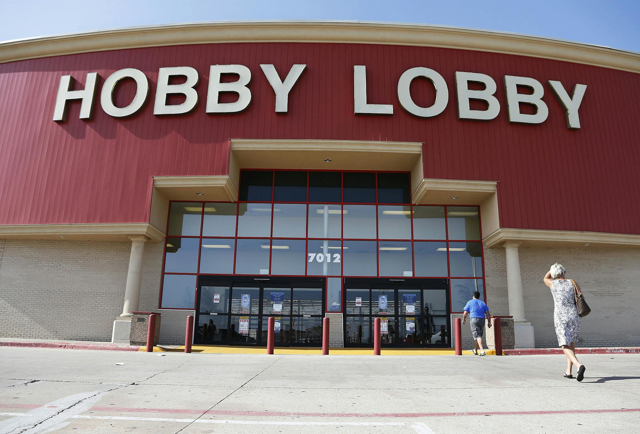 Customers walk to a Hobby Lobby store in Oklahoma City, Monday, June 30, 2014. The Supreme Court ruled Monday that employers can hold religious objections that allow them to opt out of the new health law requirement that they cover contraceptives for women. The Hobby Lobby chain of arts-and-crafts stores is by far the largest employer of any company that has gone to court to fight the birth control provision. (AP Photo/Sue Ogrocki) ORG XMIT: MIN2014070212542635