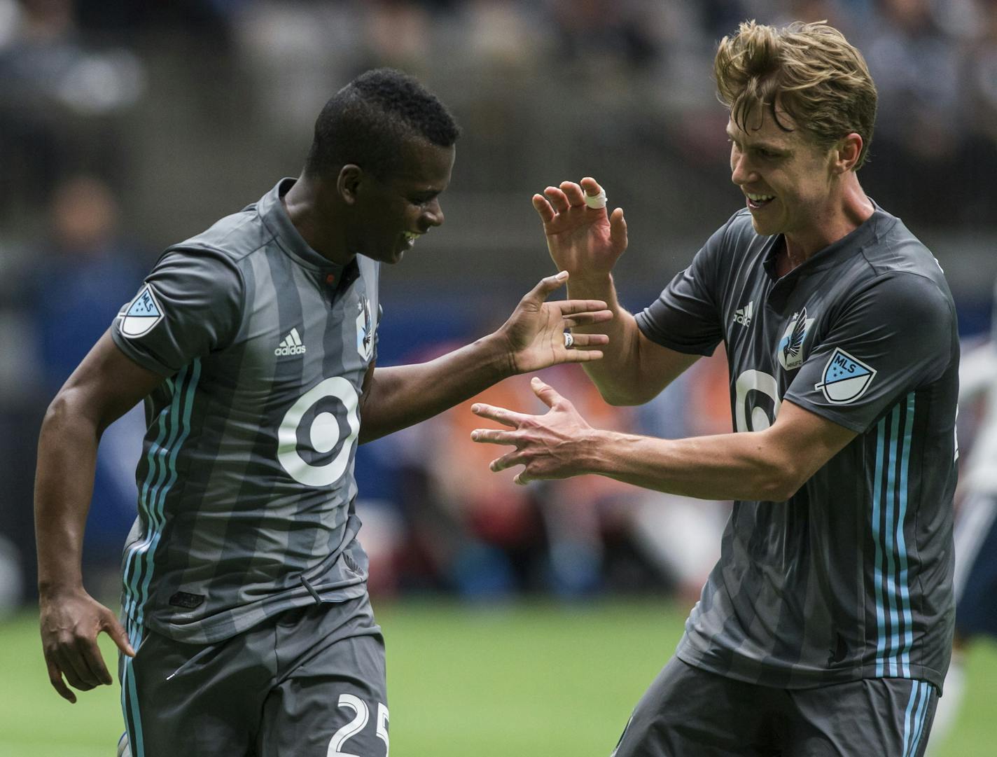 Minnesota United's Carlos Darwin Quintero (25) celebrates his goal with Rasmus Schuller during the first half of an MLS soccer match against the Vancouver Whitecaps on Saturday, March 2, 2019, in Vancouver, British Columbia. (Ben Nelms/The Canadian Press via AP)