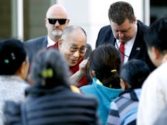 The Dalai Lama greets members of Minnesota Tibetan community upon arrival to the Mayo Civic Center, Wednesday, Sept. 30, 2015, in Rochester, Minn., fo