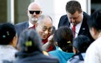 The Dalai Lama greets members of Minnesota Tibetan community upon arrival to the Mayo Civic Center, Wednesday, Sept. 30, 2015, in Rochester, Minn., fo