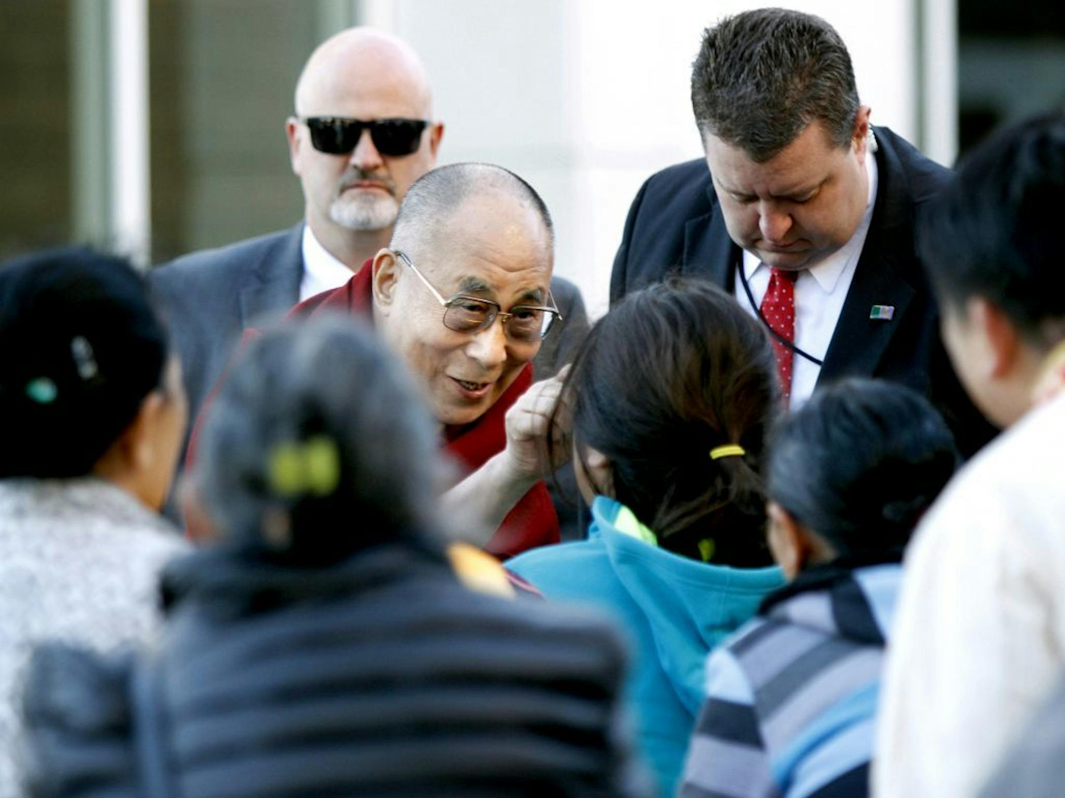The Dalai Lama greets members of Minnesota Tibetan community upon arrival to the Mayo Civic Center, Wednesday, Sept. 30, 2015, in Rochester, Minn., following his stay at the Mayo Clinic. (Elizabeth Nida Obert/The Rochester Post-Bulletin via AP) MANDATORY CREDIT ORG XMIT: MIN2015093016145703