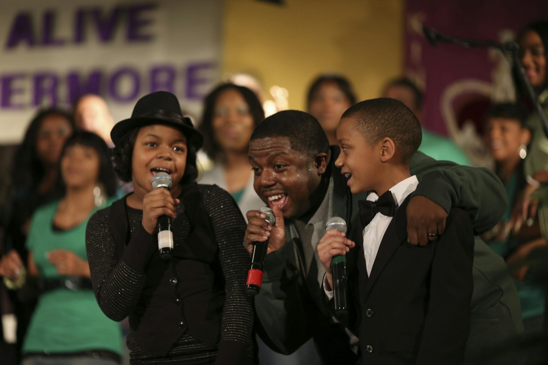 Young soloists Arielle Davis, left, and Andre Dukes, both 9, were joined by Arielle's dad, Adrian Davis, music director at Shiloh Temple, at the end of their song at a Sunday night concert.