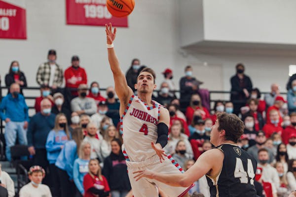 St. John's senior guard Colton Codute went up for a layup against St. Olaf forward Carter Uphus in an MIAC men's basketball playoff game Friday, Feb. 