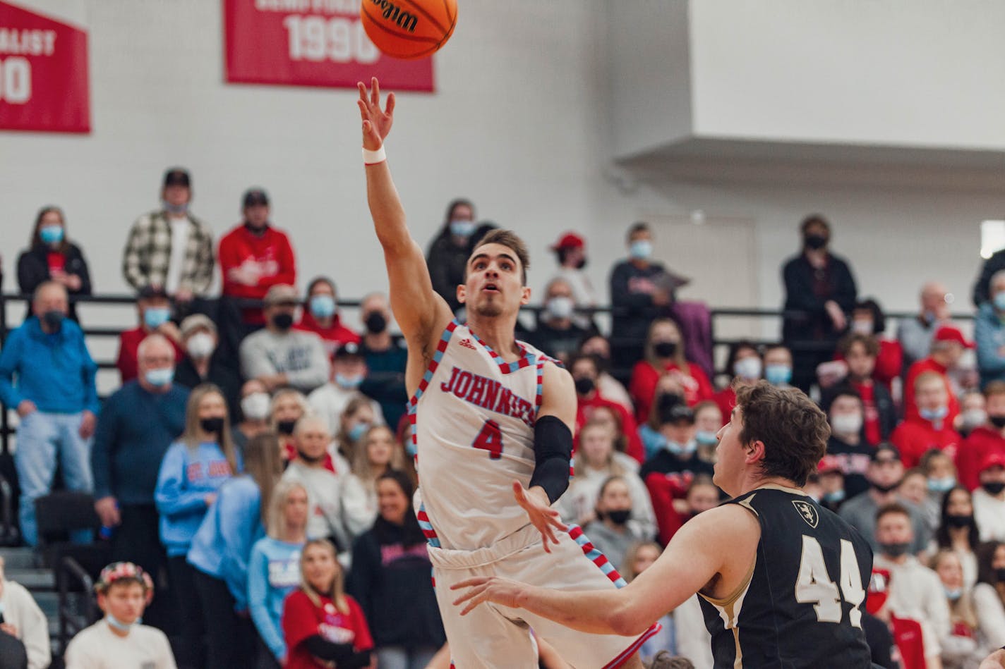 St. John's senior guard Colton Codute went up for a layup against St. Olaf forward Carter Uphus in an MIAC men's basketball playoff game Friday, Feb. 25, 2022, in St. Joseph, Minn. (Rafael Alvarez, St. John's University)