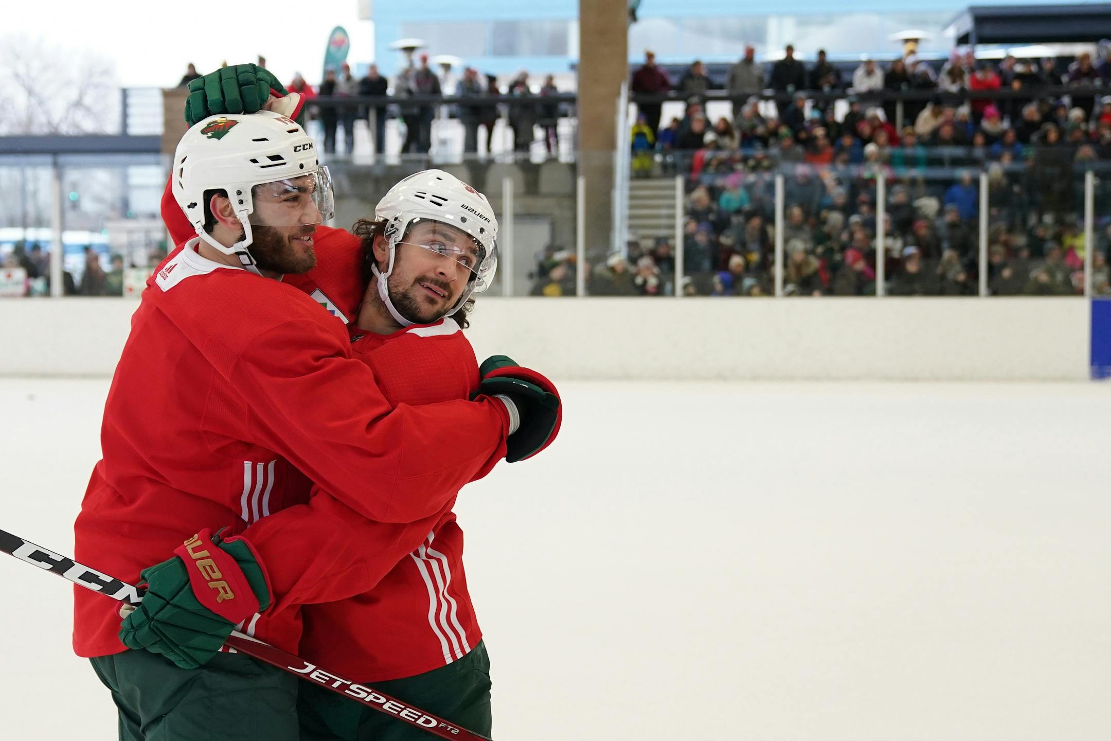 Minnesota Wild right wing Mats Zuccarello (36) celebrated with center Luke Kunin (19) after they scored on goaltender Devan Dubnyk (40) during the Wild's outdoor practice Thursday.