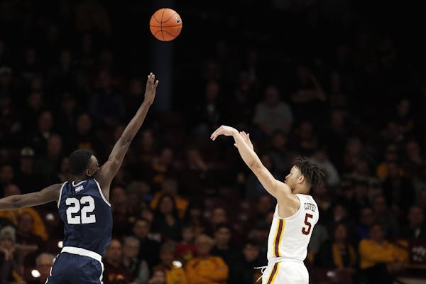 Minnesota guard Amir Coffey (5) shoots as Mount St. Mary's forward Nana Opoku (22) defends during the second half.