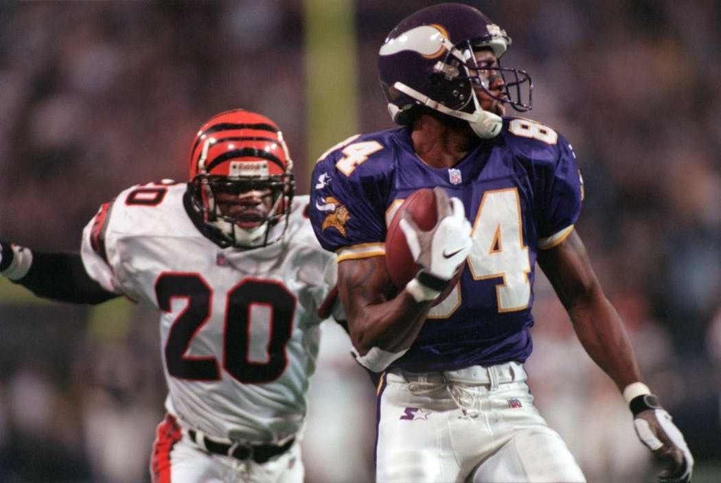 Randy Moss catches a touchdown pass at the Metrodome during his rookie season.