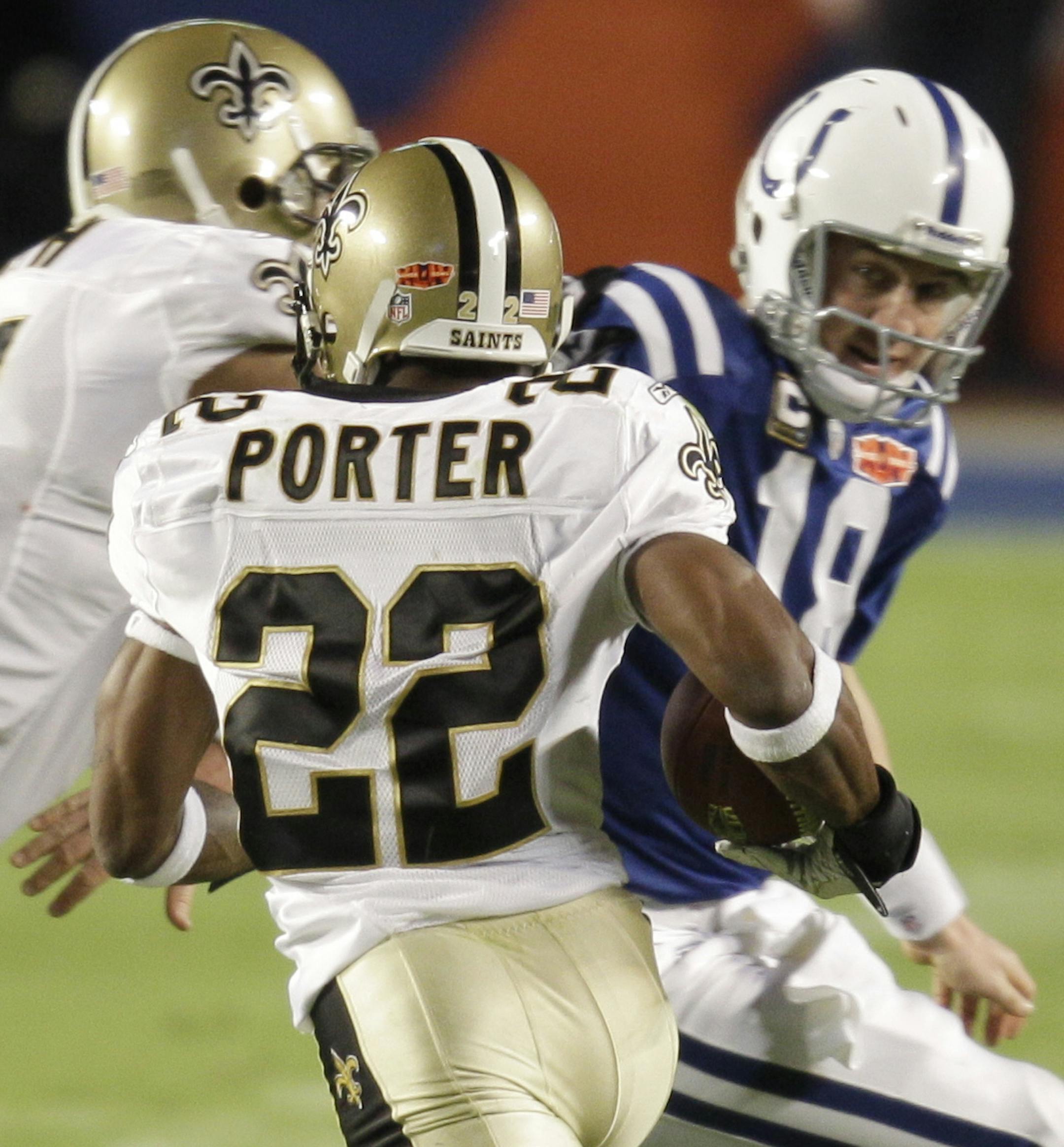 New Orleans Saints defensive end Will Smith, left, blocks Indianapolis Colts quarterback Peyton Manning (18) as Saints cornerback Tracy Porter (22) carries an intercepted pass for a touchdown during the second half of the NFL Super Bowl XLIV football game in Miami, Sunday, Feb. 7, 2010. (AP Photo/Chuck Burton) ORG XMIT: SB419